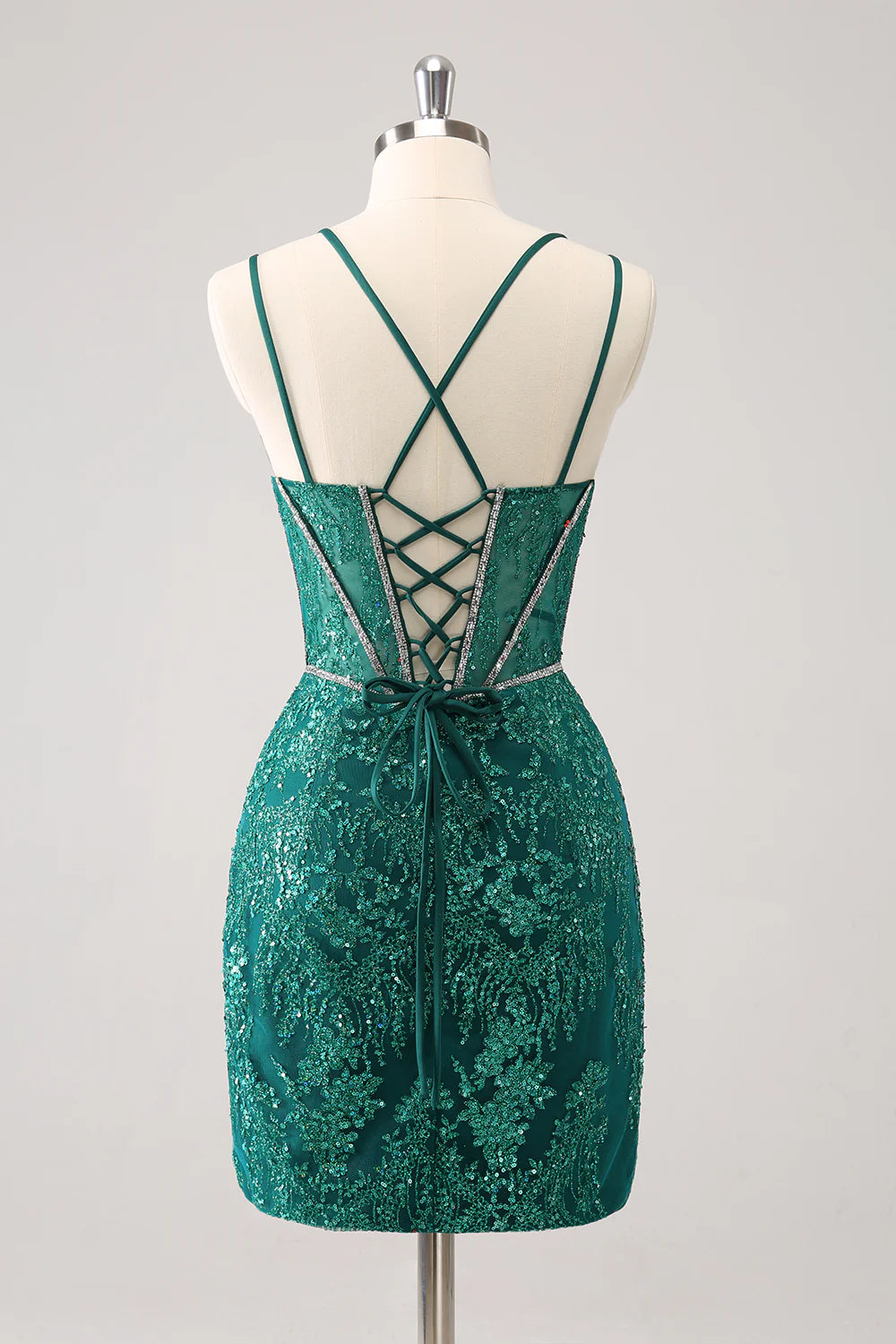 Back view of a model in a dark green glitter corset short homecoming dress, showing lace-up detail.