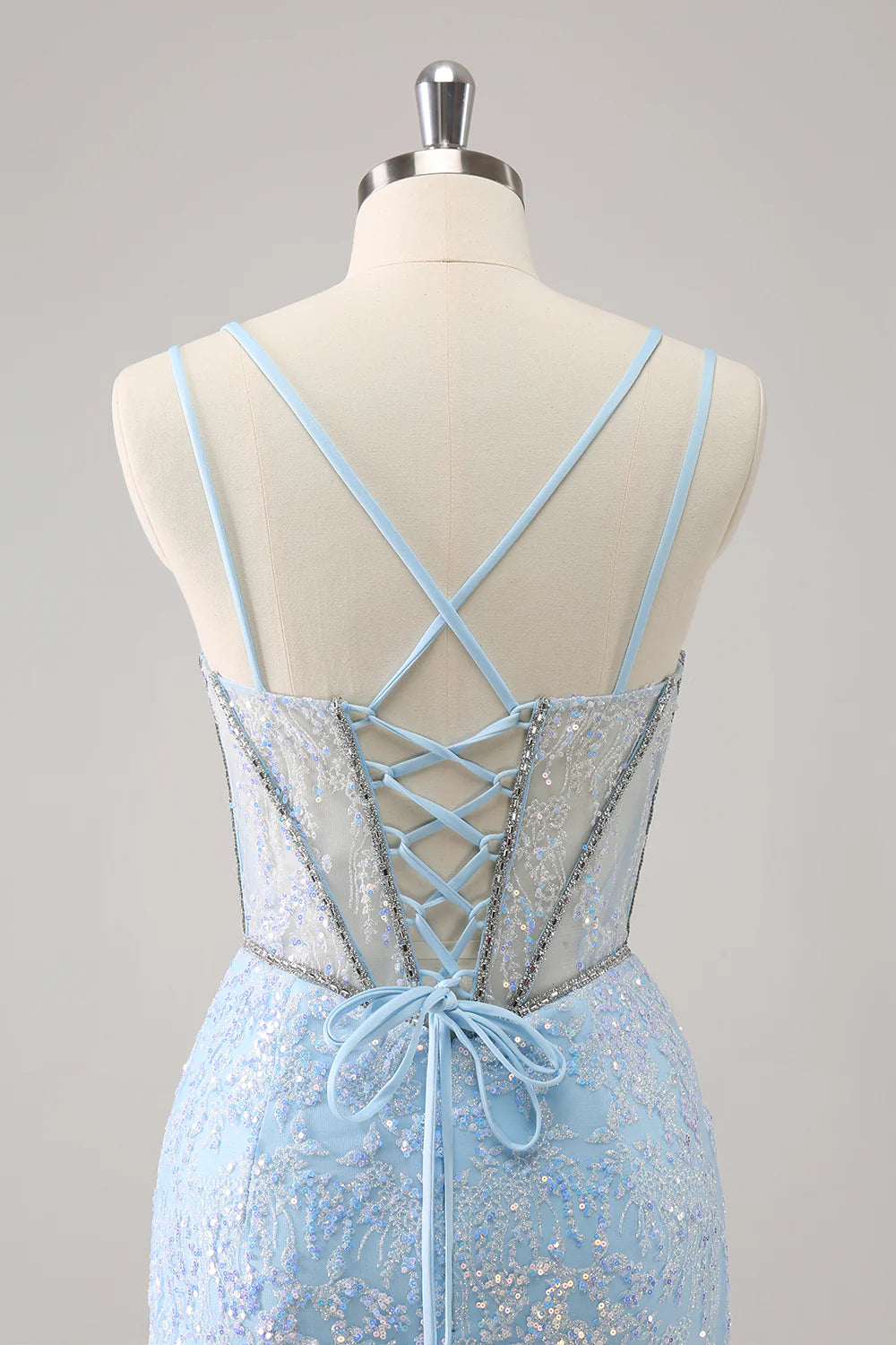 Back view of a model in a light blue glitter corset short homecoming dress, showing lace-up detail.