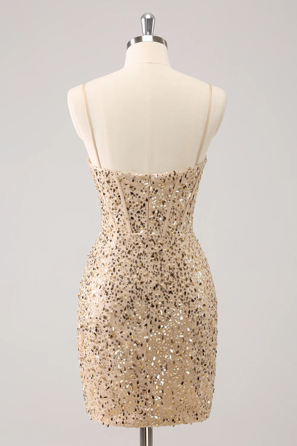 Side view of a golden sequin bodycon short dress with delicate spaghetti straps.