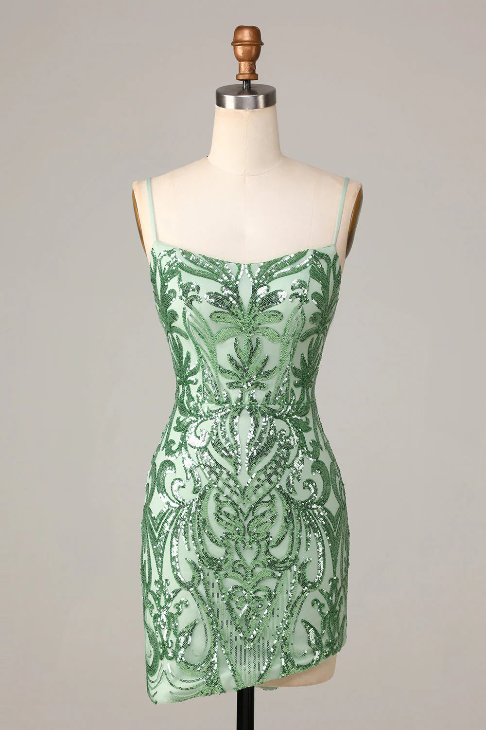 Front view of a sparkling green sequin bodycon homecoming dress with spaghetti straps.