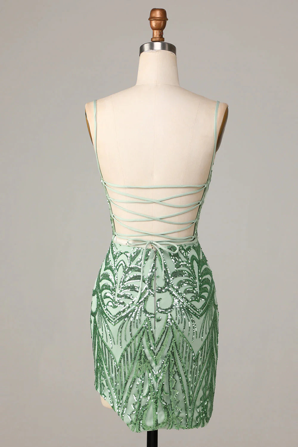 Back view of a green sequin bodycon dress featuring a chic backless design.