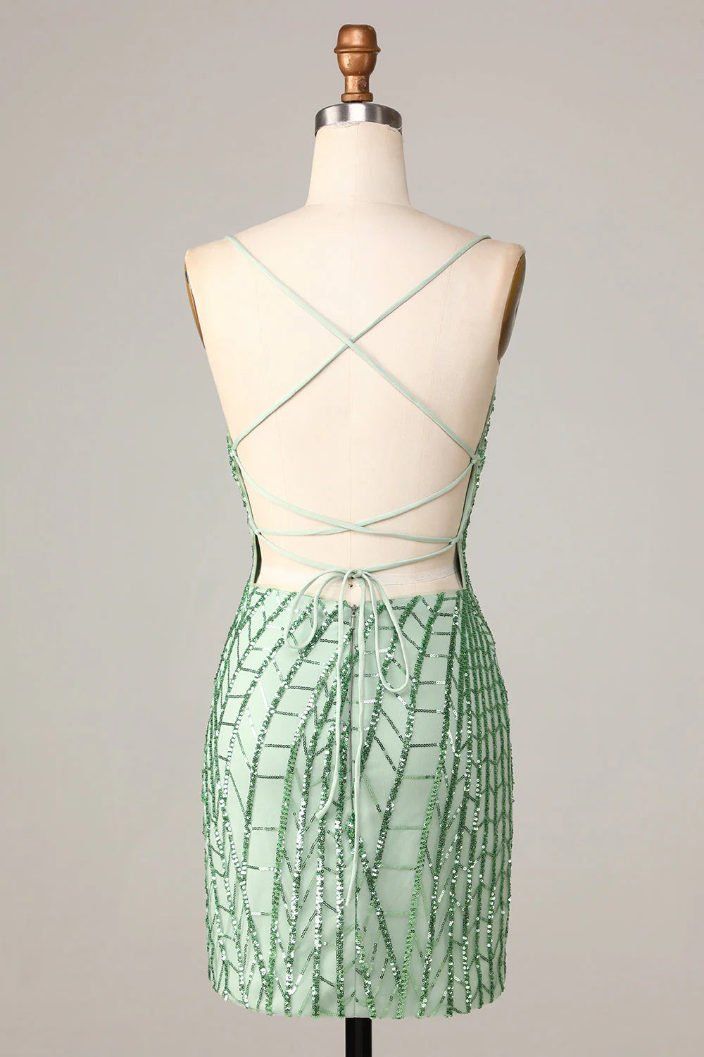 Back view of green sequin homecoming dress with criss-cross straps.