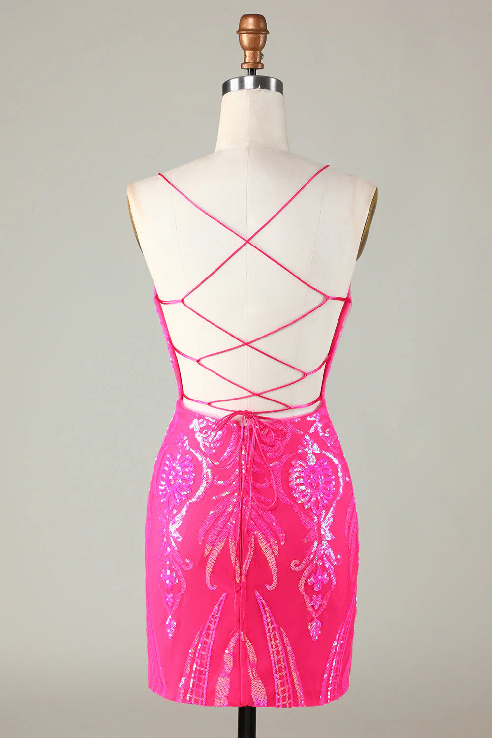 Side view of the hot pink glitter short dress with a fitted silhouette.