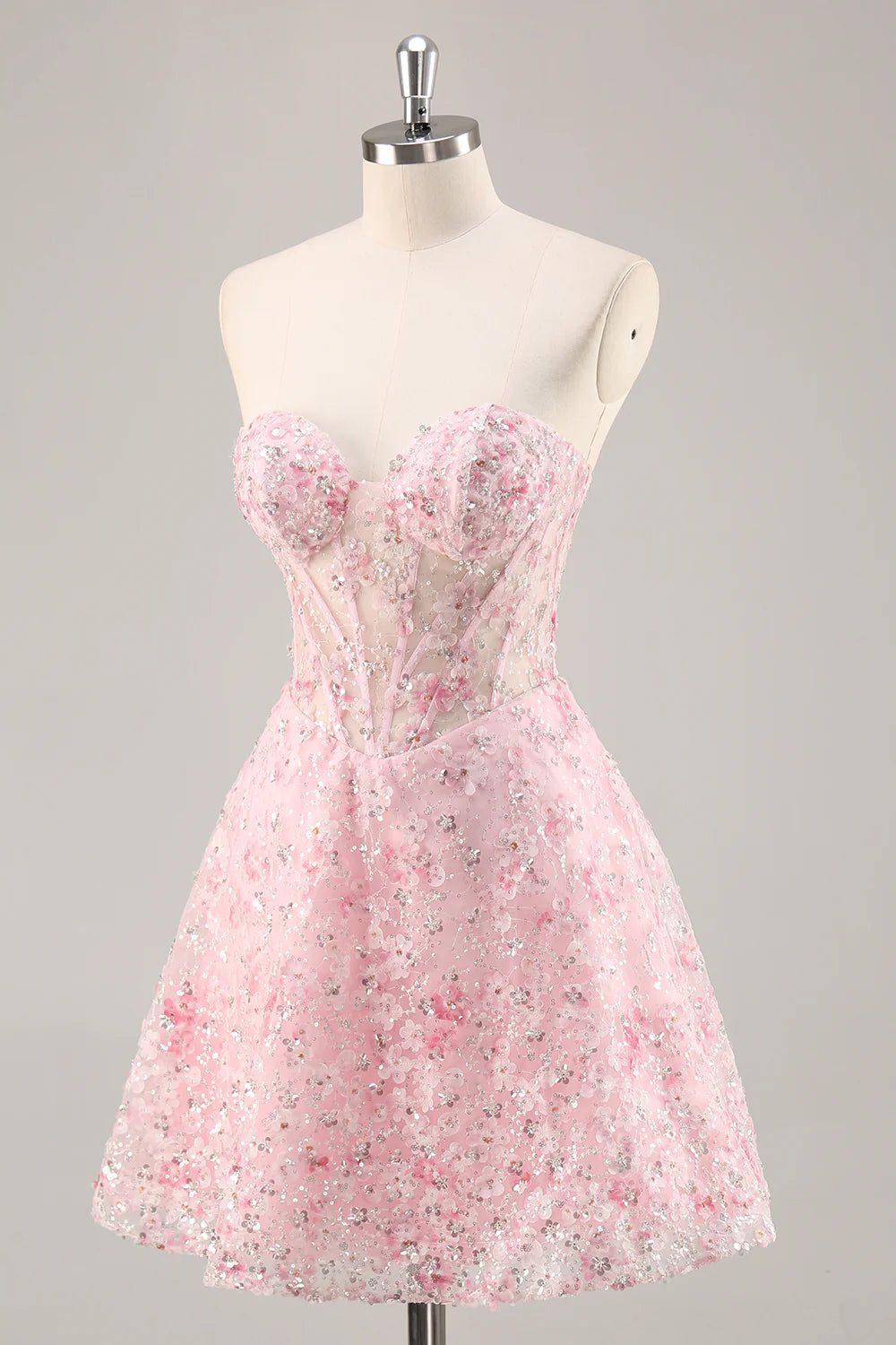 Close-up of sequin and floral details on a pink homecoming dress.