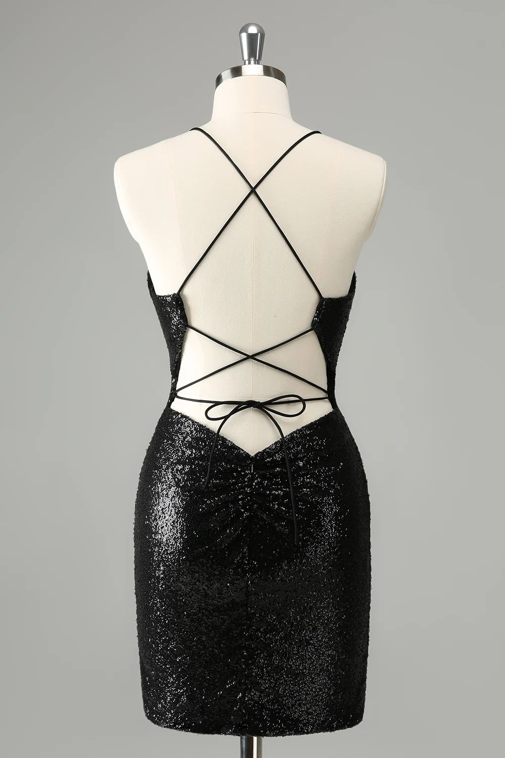 Back view of a black sequined bodycon dress showing the lace-up detail.