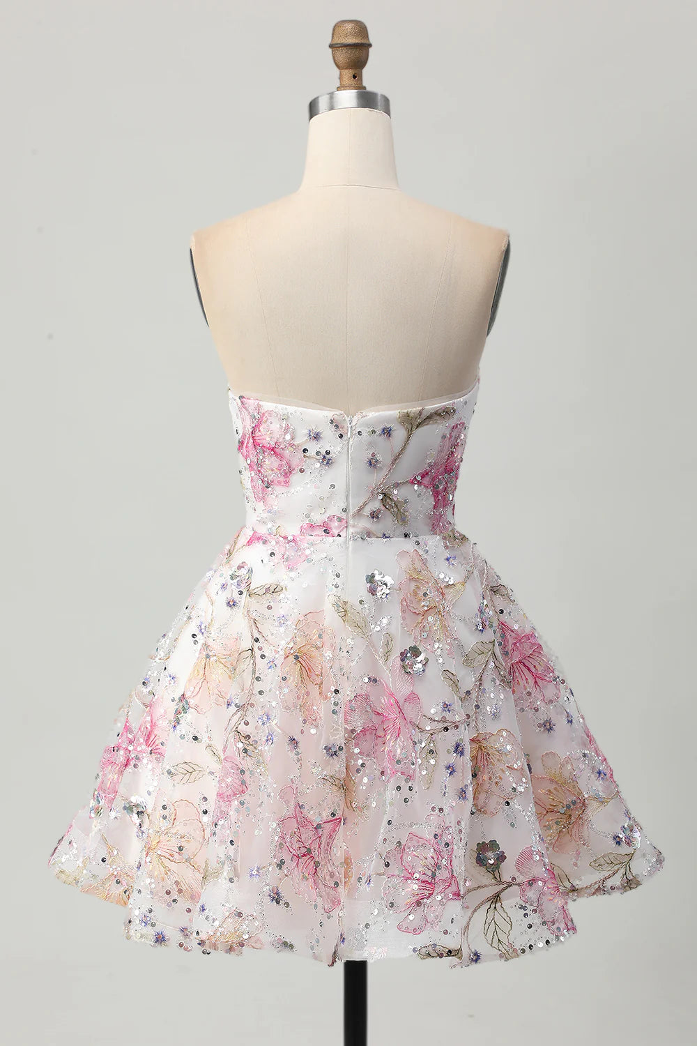 Side view of a pink floral A-line strapless short homecoming dress with sequins.