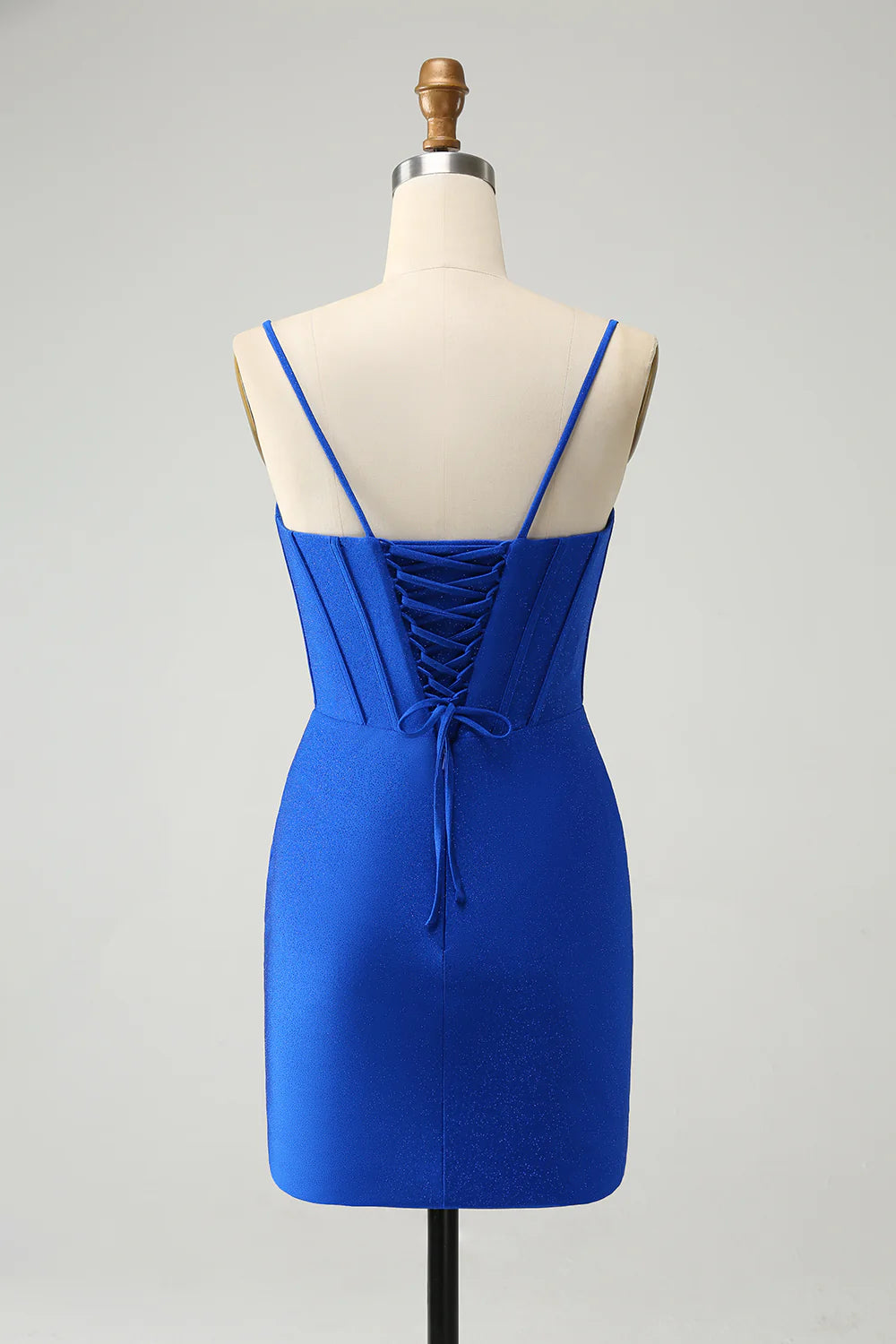 Side view of royal blue tight homecoming dress, showing glitter fabric and beaded details.