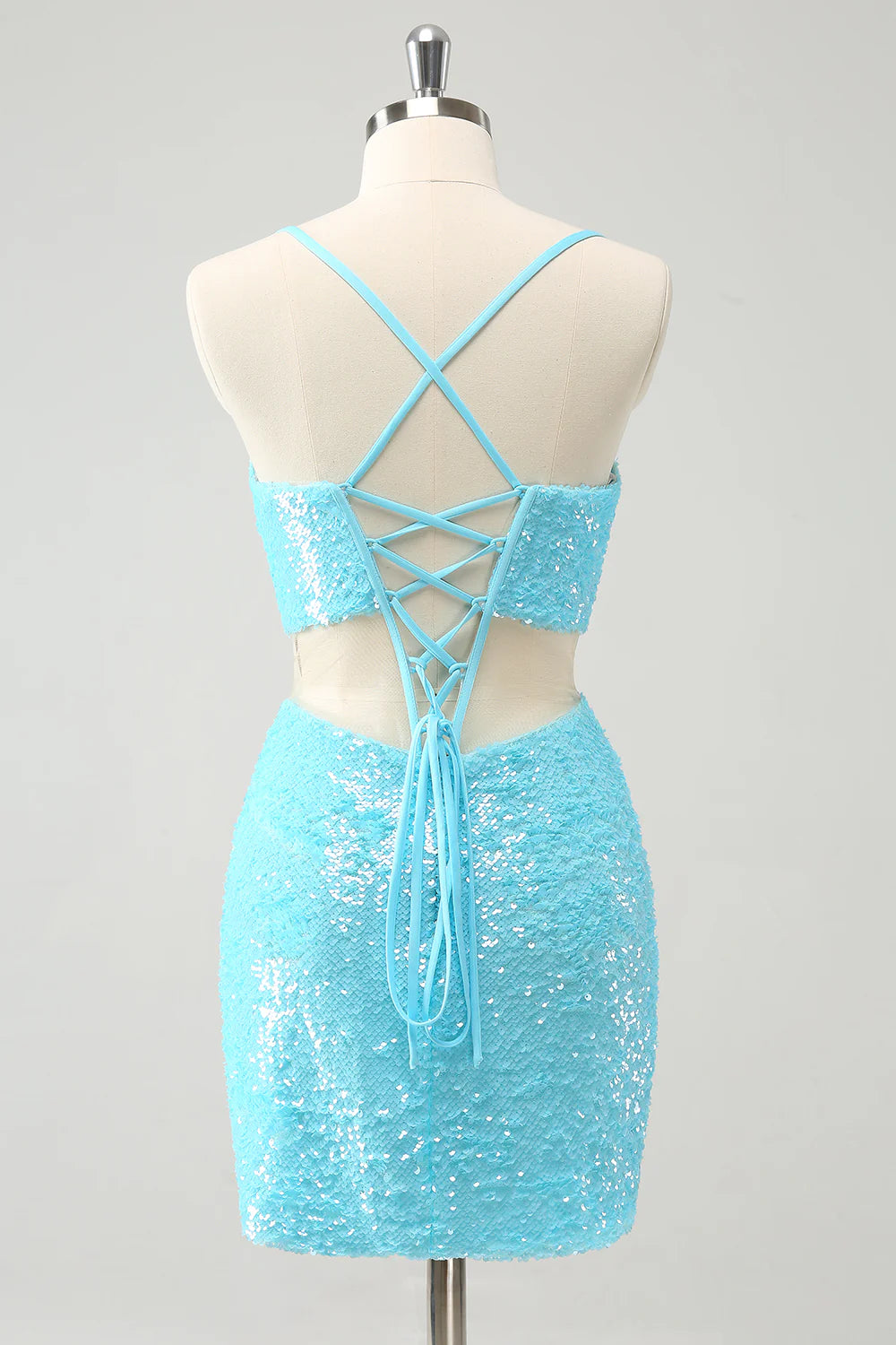 Back view of a model in a tight light blue sequin spaghetti strap homecoming dress.