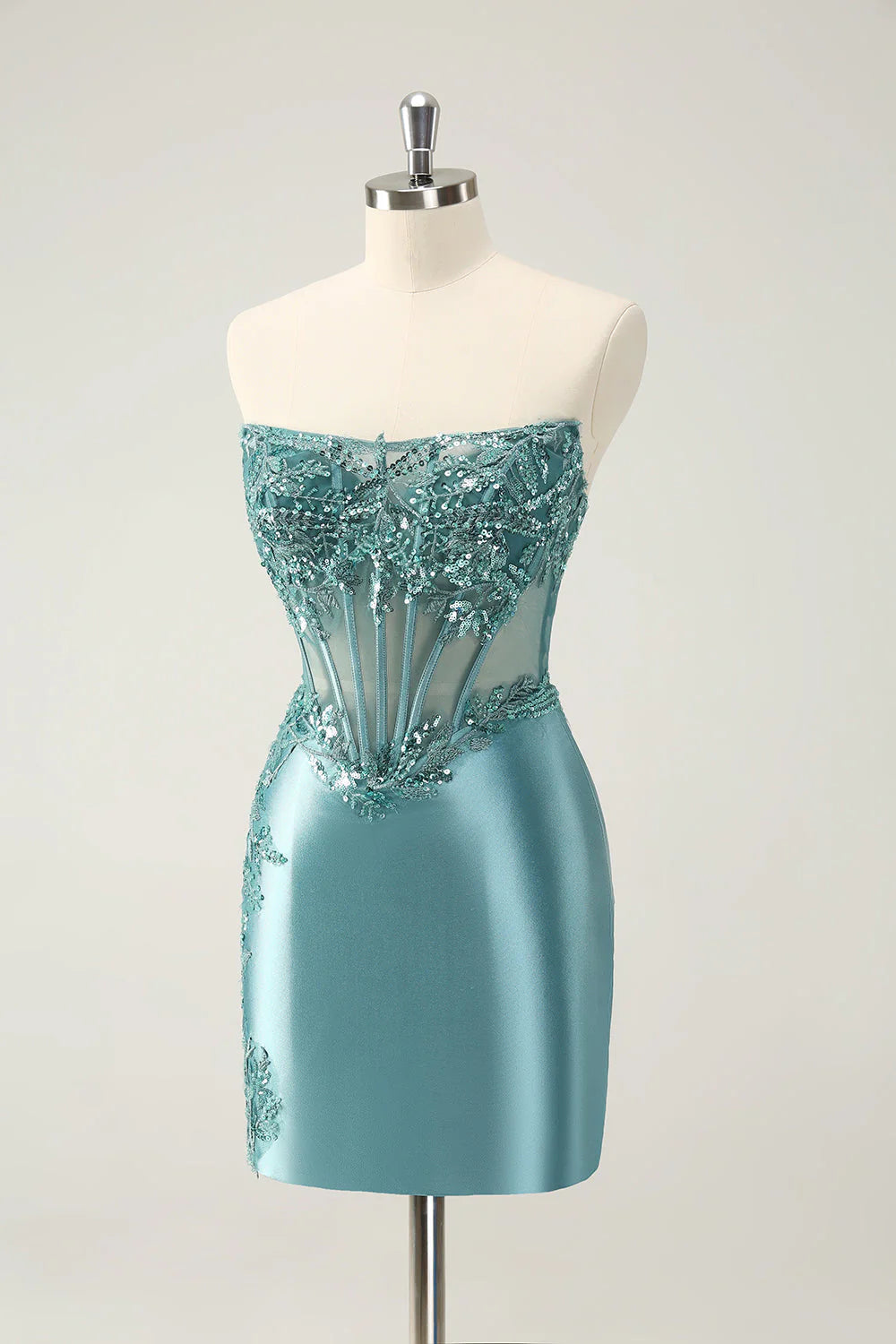 Side view of short peacock blue glitter dress with appliques.