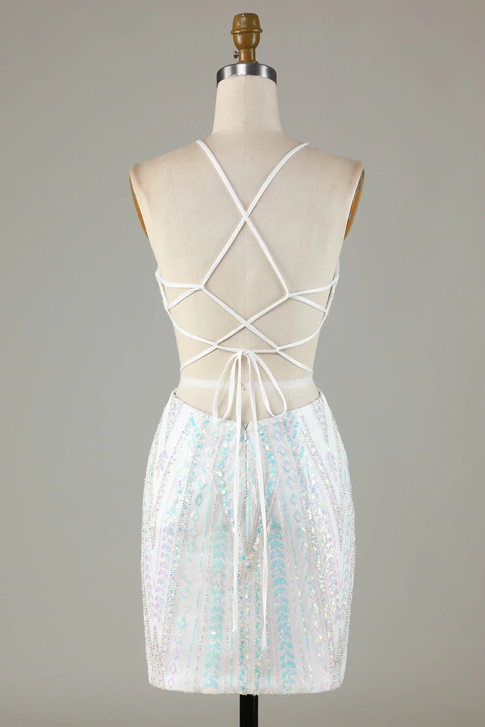 Close-up of the lace-up back detail on the white sequin halter dress.