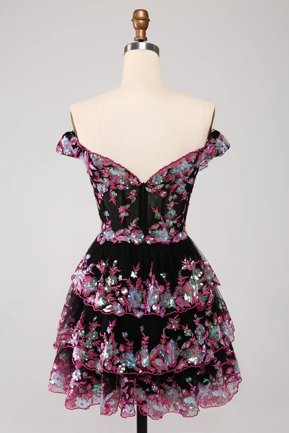 Back view of a sparkly black and pink off-shoulder homecoming dress with corset detailing.