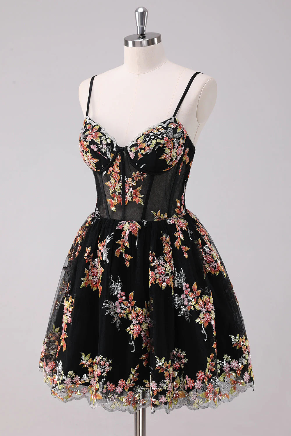 Back view of the sparkly black A-line dress with floral accents.