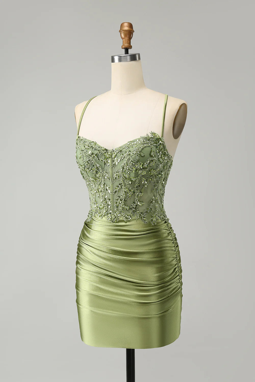 Close-up of the sparkly light green corset bodice with sequin details and spaghetti straps.