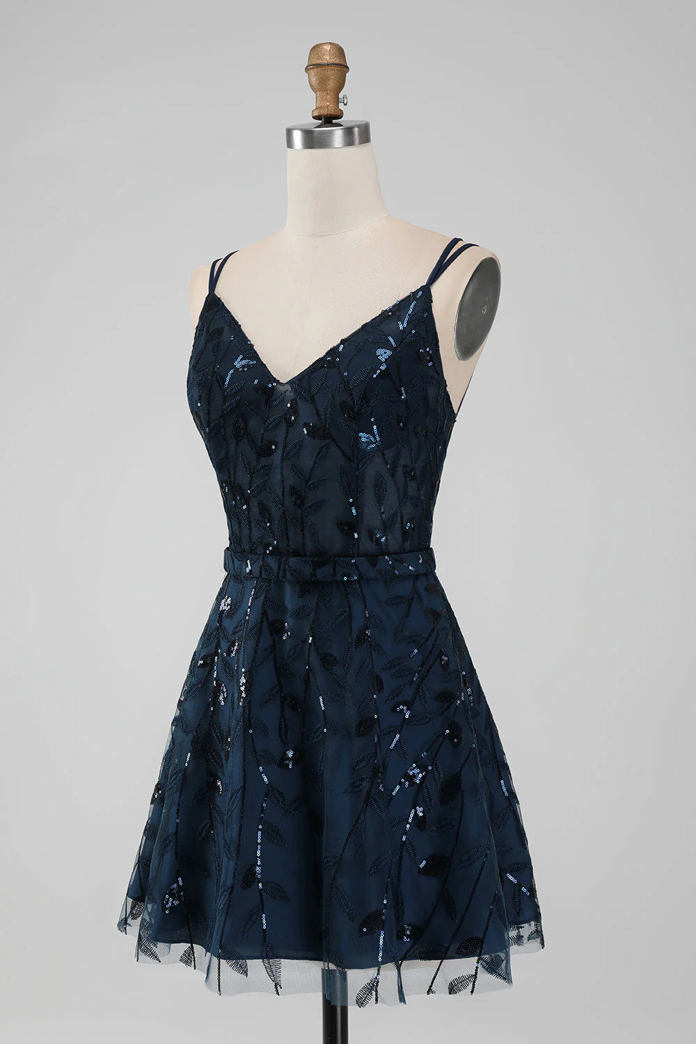 Side view of a short navy A-line sequin dress with spaghetti straps.