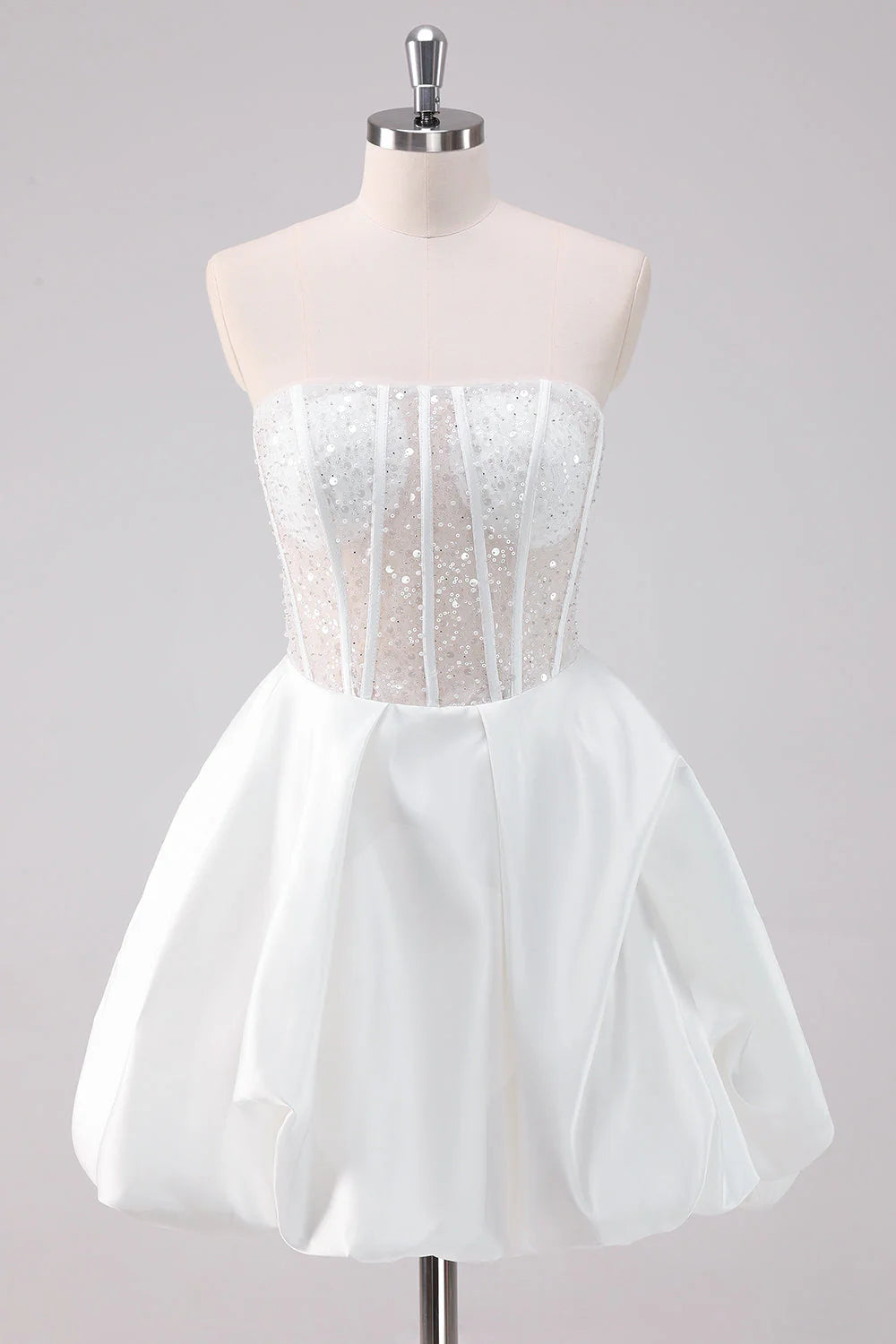 Model wearing a sparkly white A-line strapless corset short homecoming dress, front view.