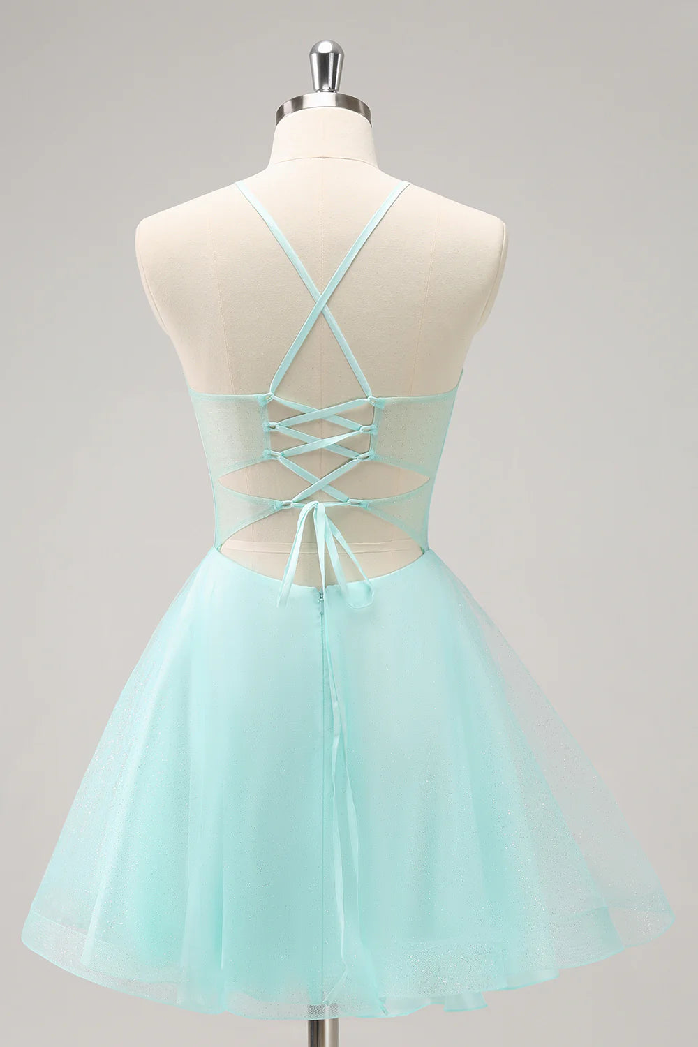 Back view of a sparkly green short homecoming dress with sequin details.