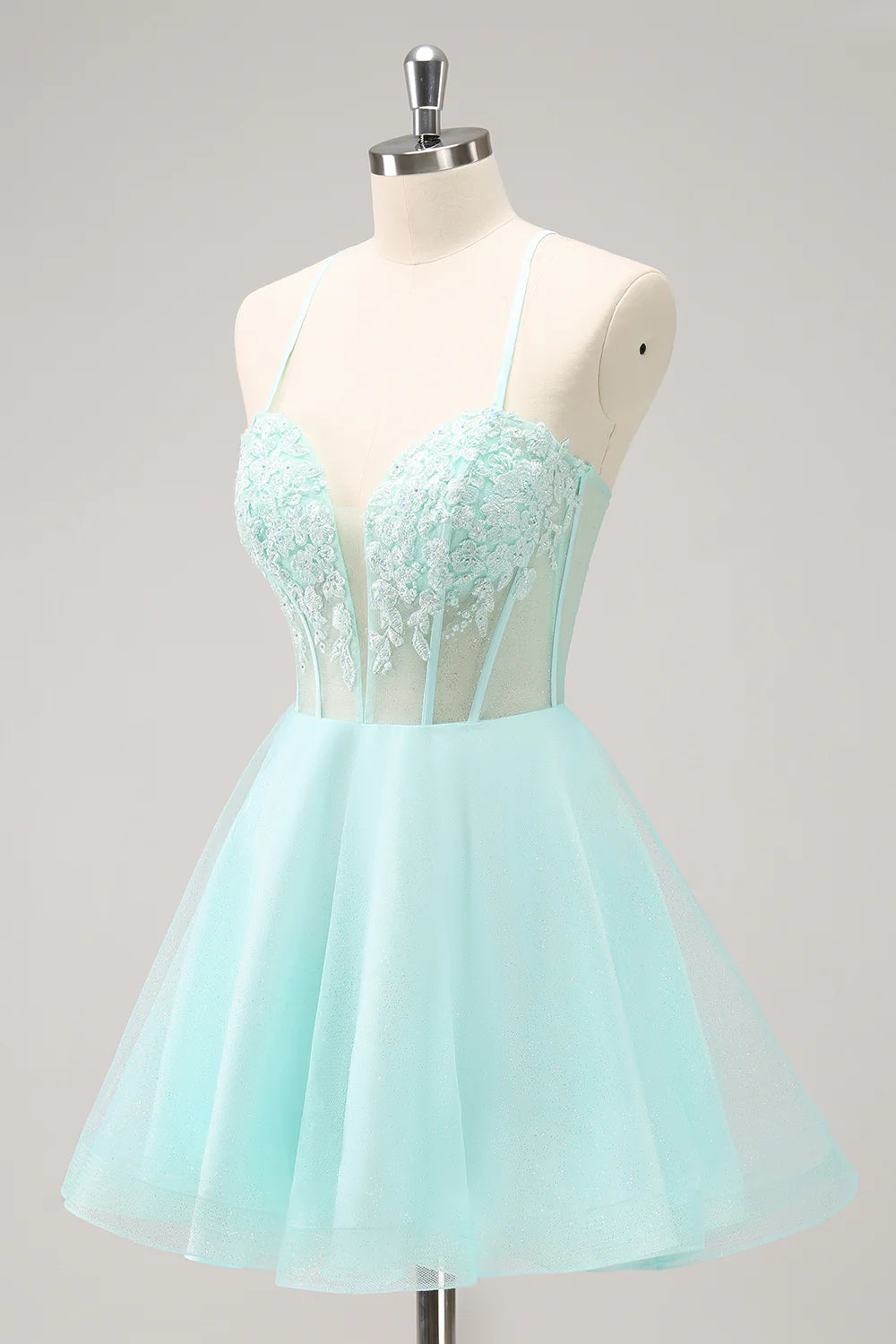 Side view of a model wearing a green strapless A-line party dress.