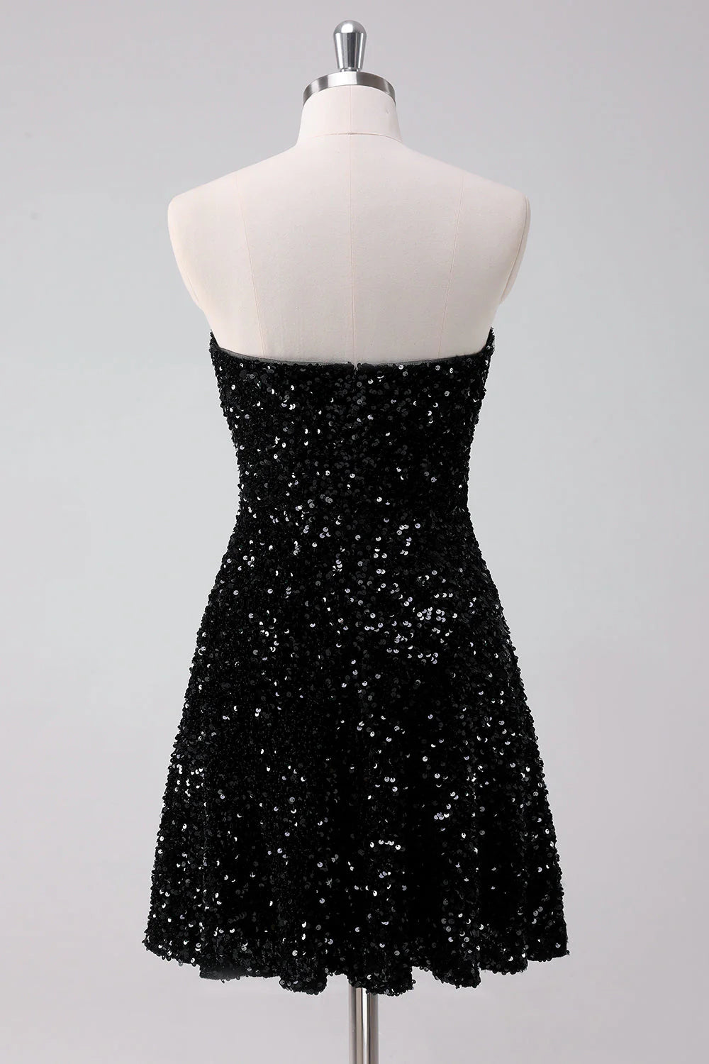 Back view of a sparkly black A-line strapless short homecoming dress with sequins.