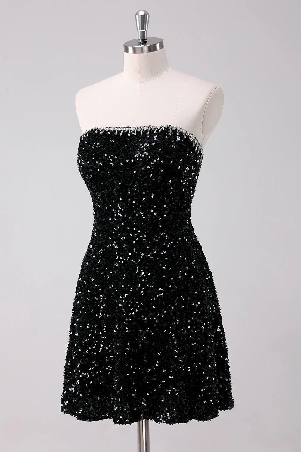 Side view of a sparkly black A-line strapless short homecoming dress with sequins.