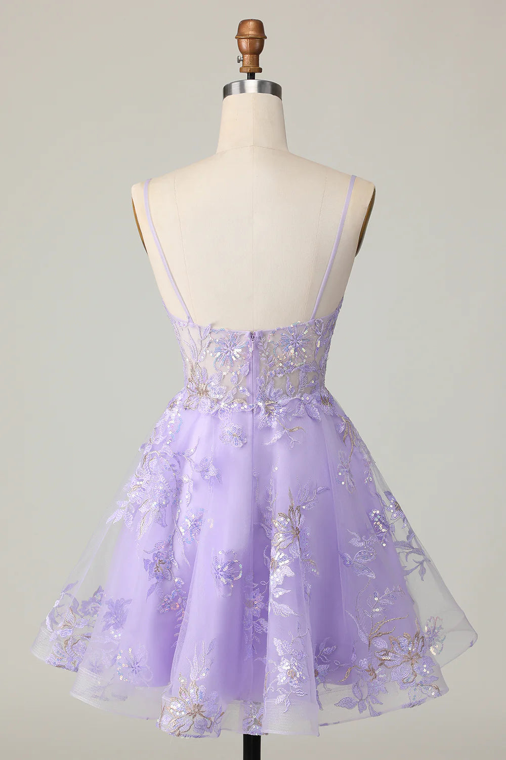 Close-up of the sequin floral details on a sparkly purple A-line strapless dress.