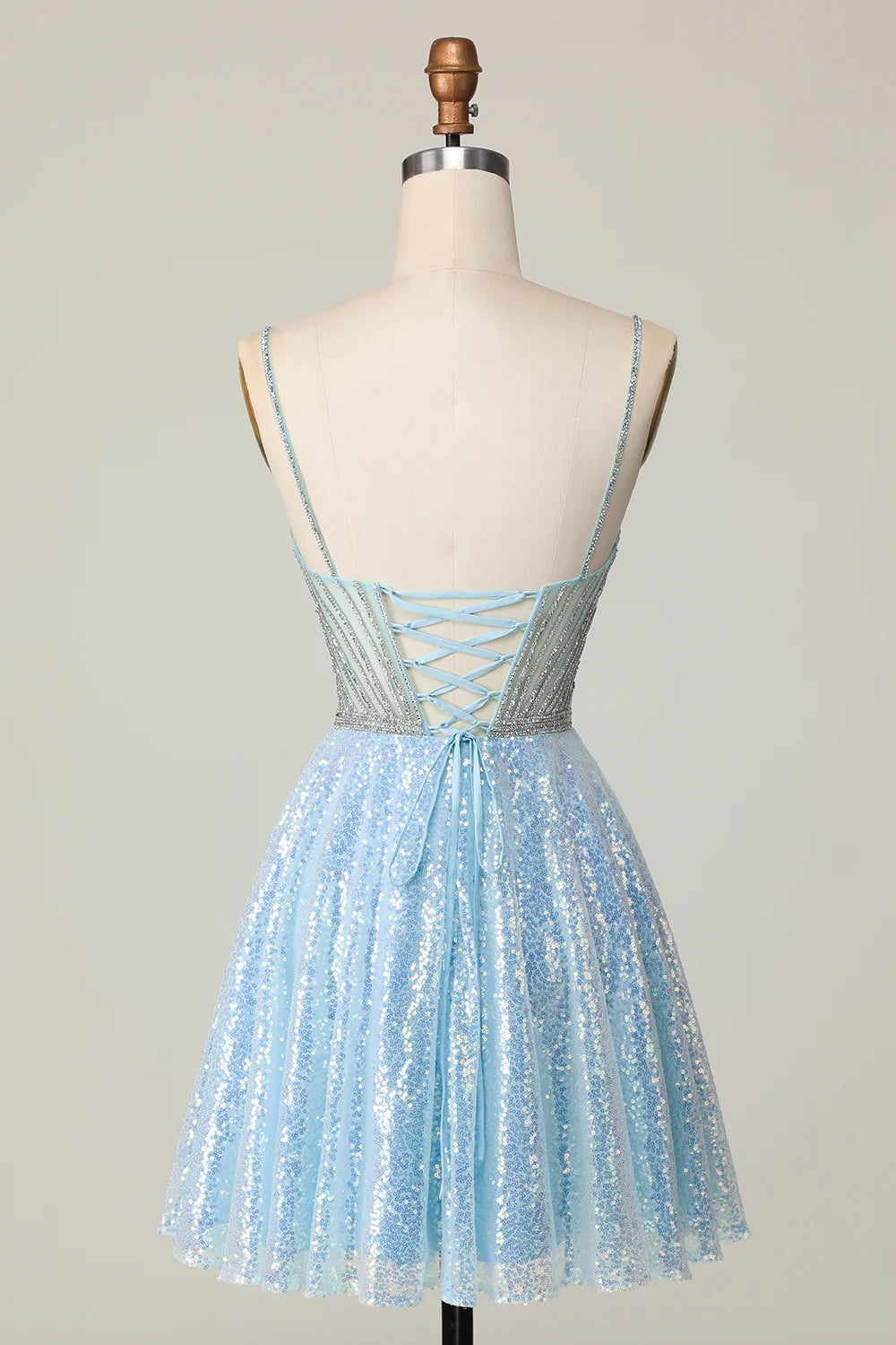 Side view of a sparkly A-line light blue sequined homecoming dress.