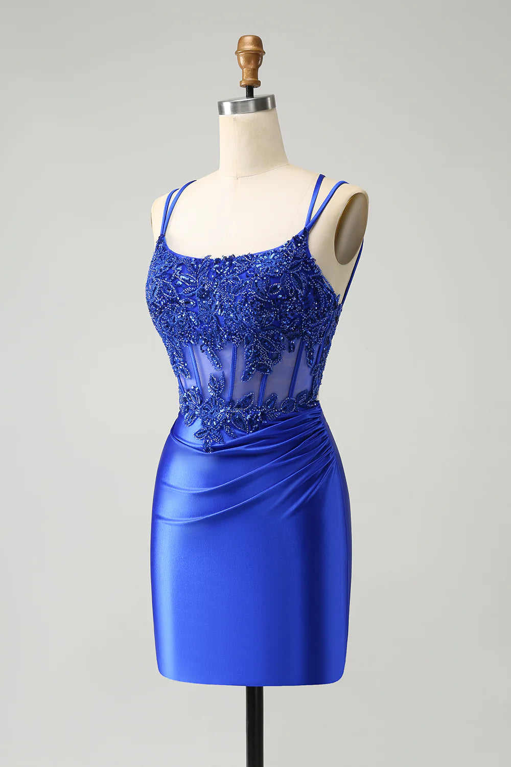 Full view of a model wearing the sparkly royal blue A-line homecoming dress with a beaded corset.