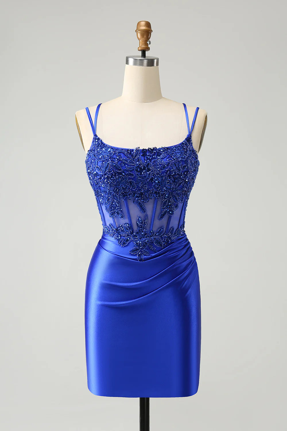 Close-up of the beaded corset bodice and strapless sweetheart neckline of the sparkly royal blue dress.