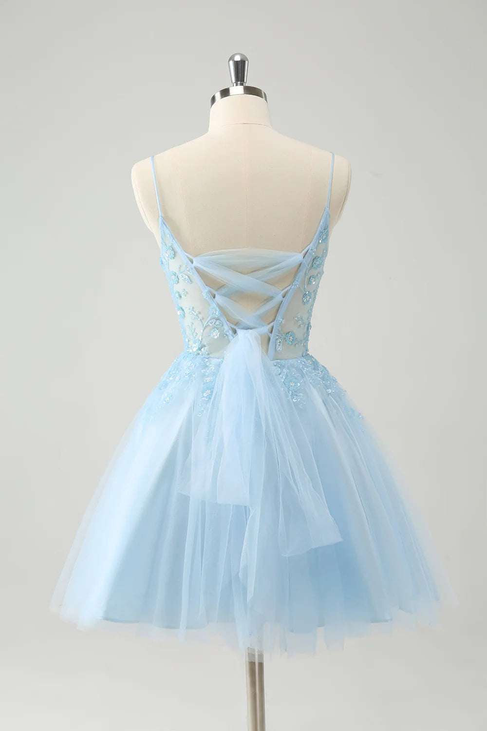 Close-up of the sequined fabric and sweetheart neckline of the blue homecoming dress.