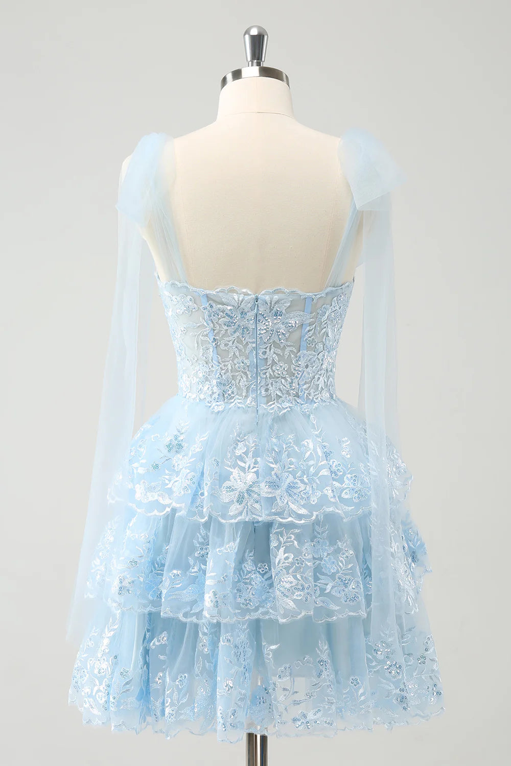 Close-up of the tiered skirt and corset detail on the blue homecoming dress.