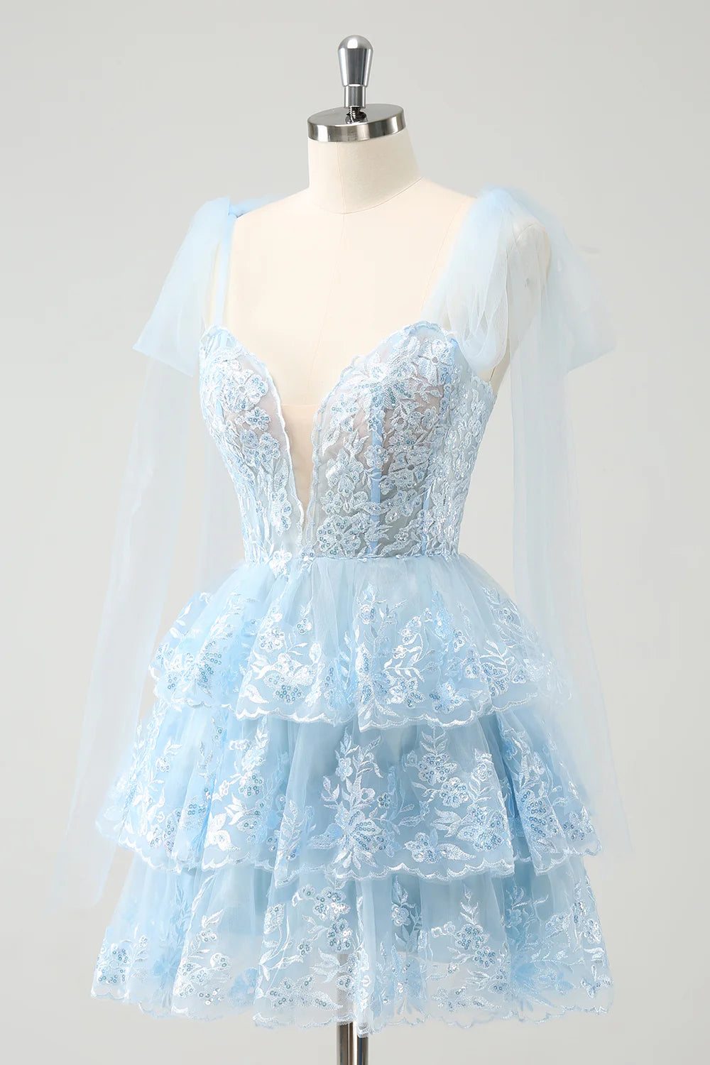 Back view of the sparkly blue A-line V-neck short homecoming dress.