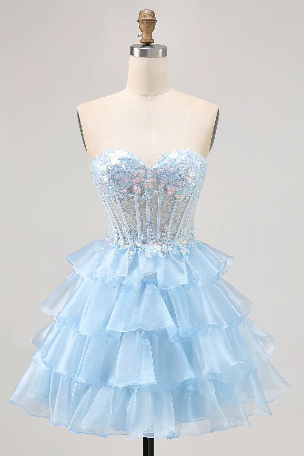 Sparkly blue A-line homecoming dress with sweetheart neckline and corset detail.