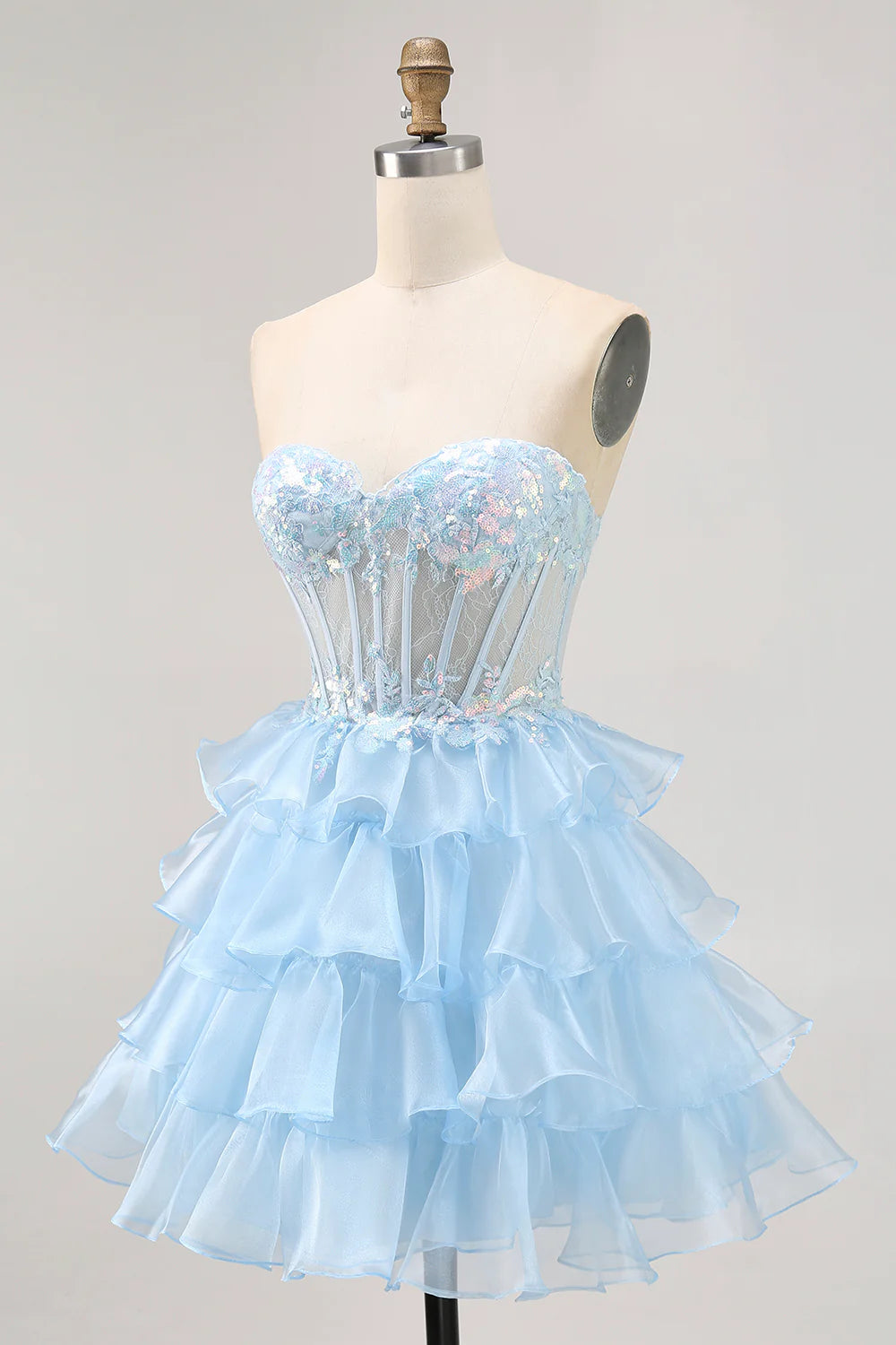 Side view of a blue sequin A-line homecoming dress, showing the short length.