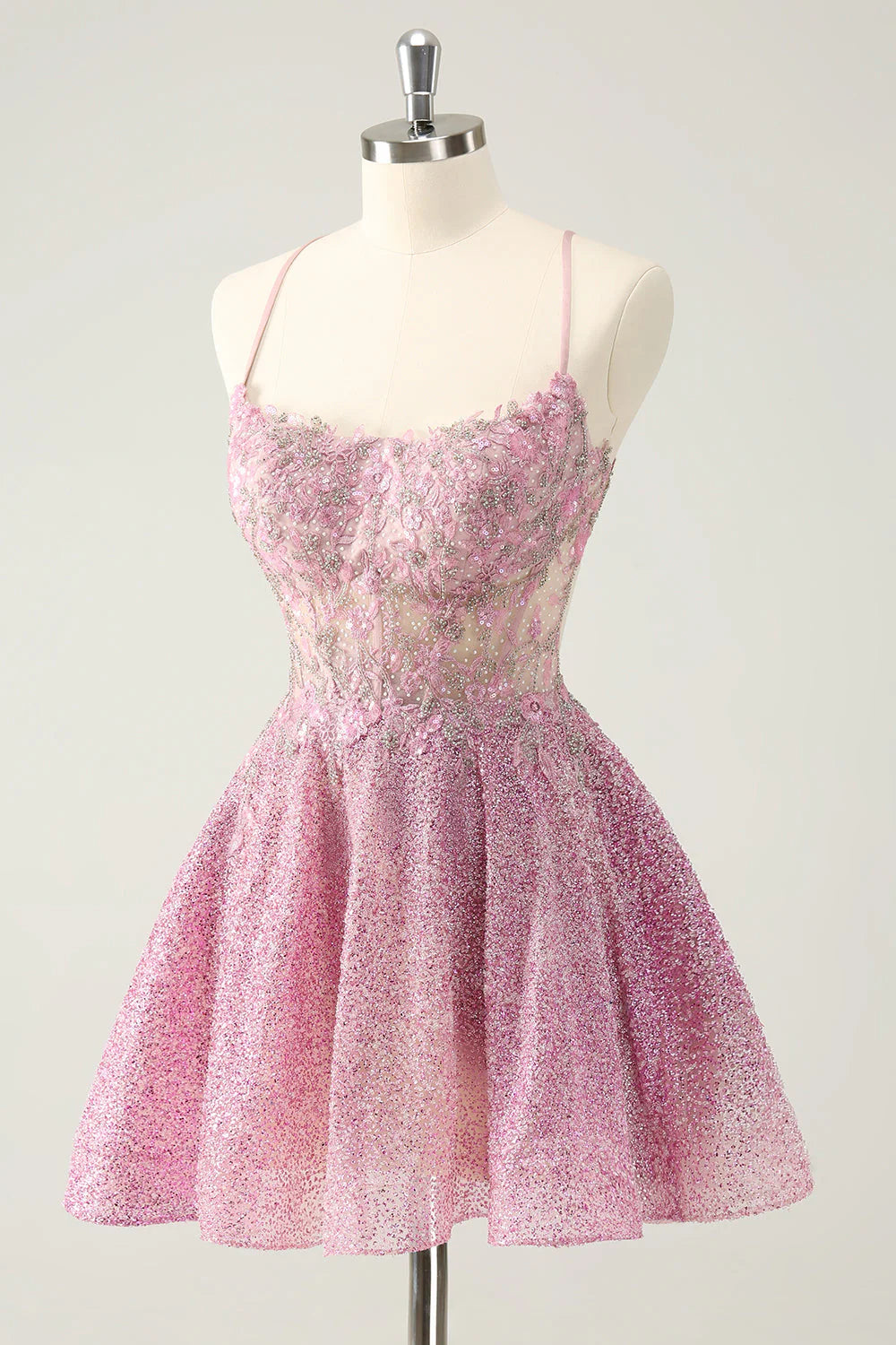 Close-up of the beaded and appliqued details on the dark pink A-line homecoming dress.