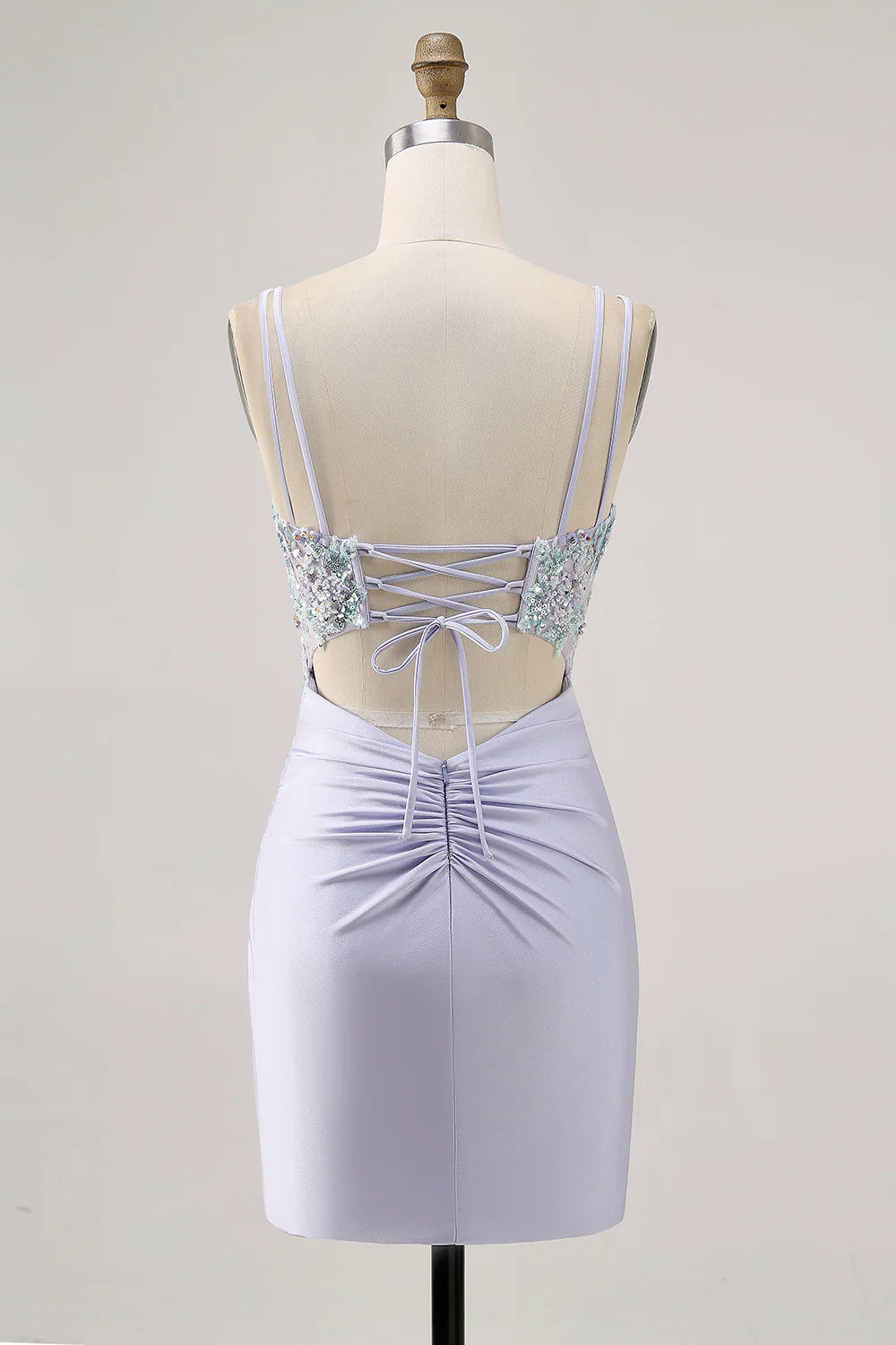 Close-up of the back of a sparkly lavender dress, showing the intricate lace-up corset detail.