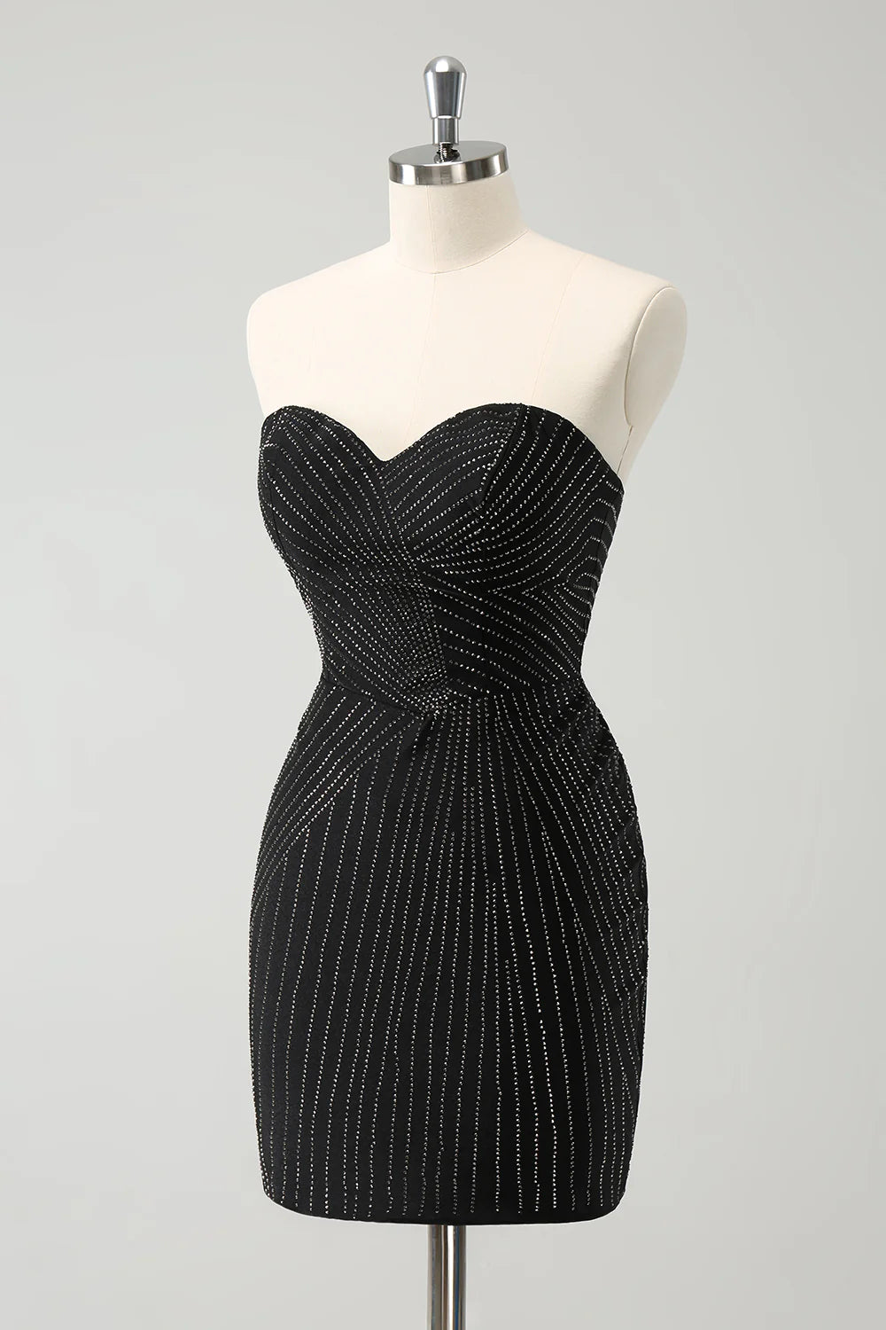 Close-up of the beaded detail on a sparkly black strapless dress.