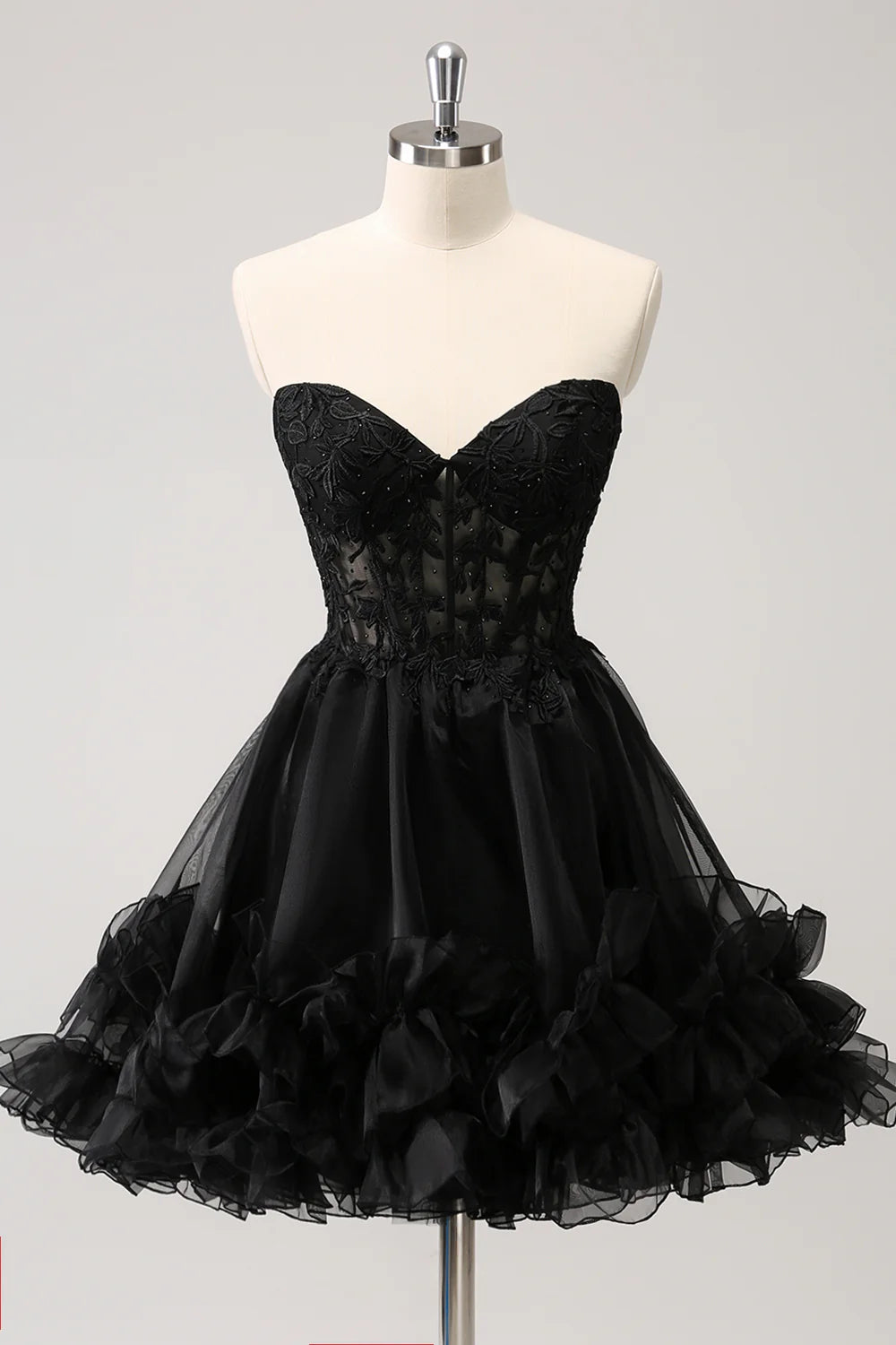 Sparkly black A-line homecoming dress with sweetheart neckline and beaded corset.