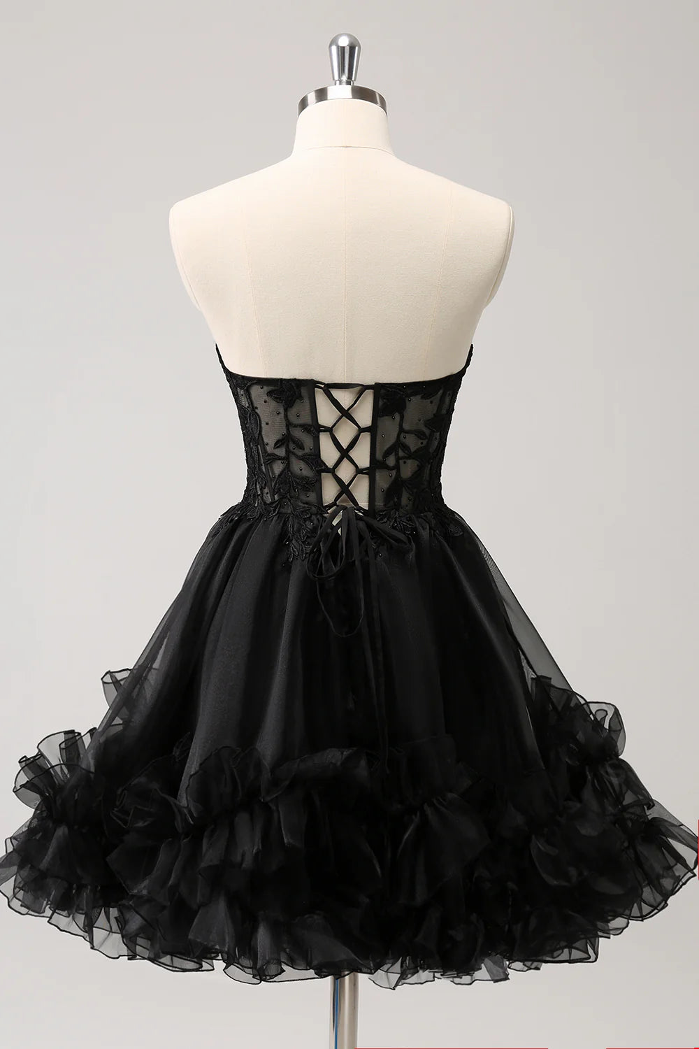 Side view of sparkly black A-line dress showing full skirt.