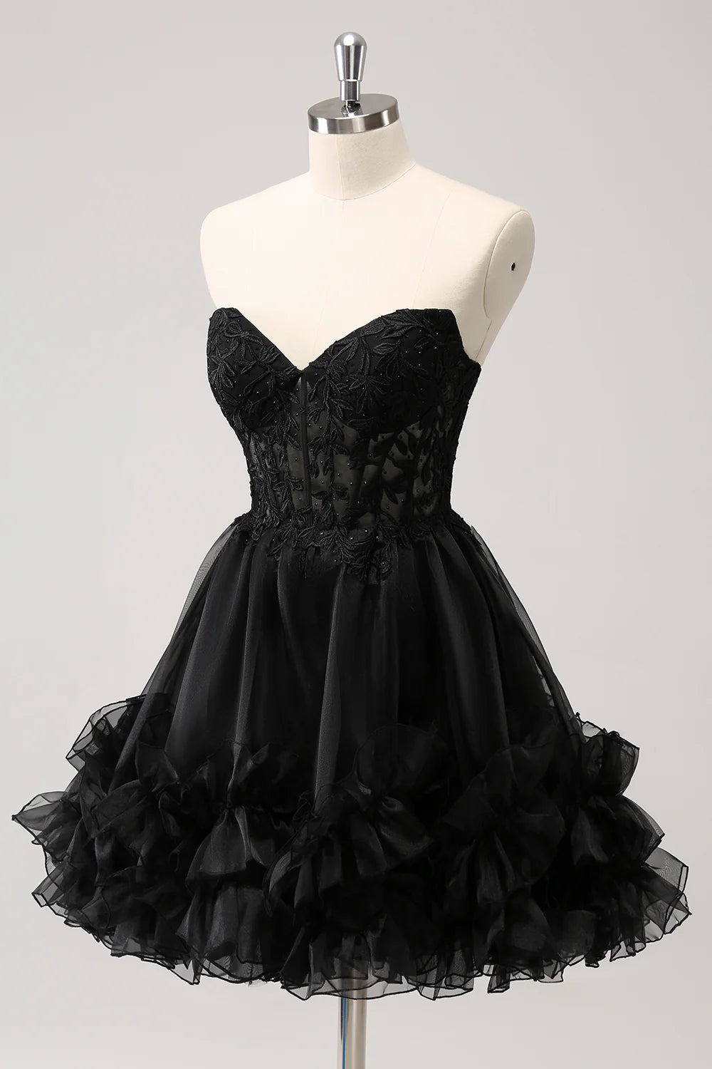 Back view of sparkly black A-line dress with elegant lace-up closure.