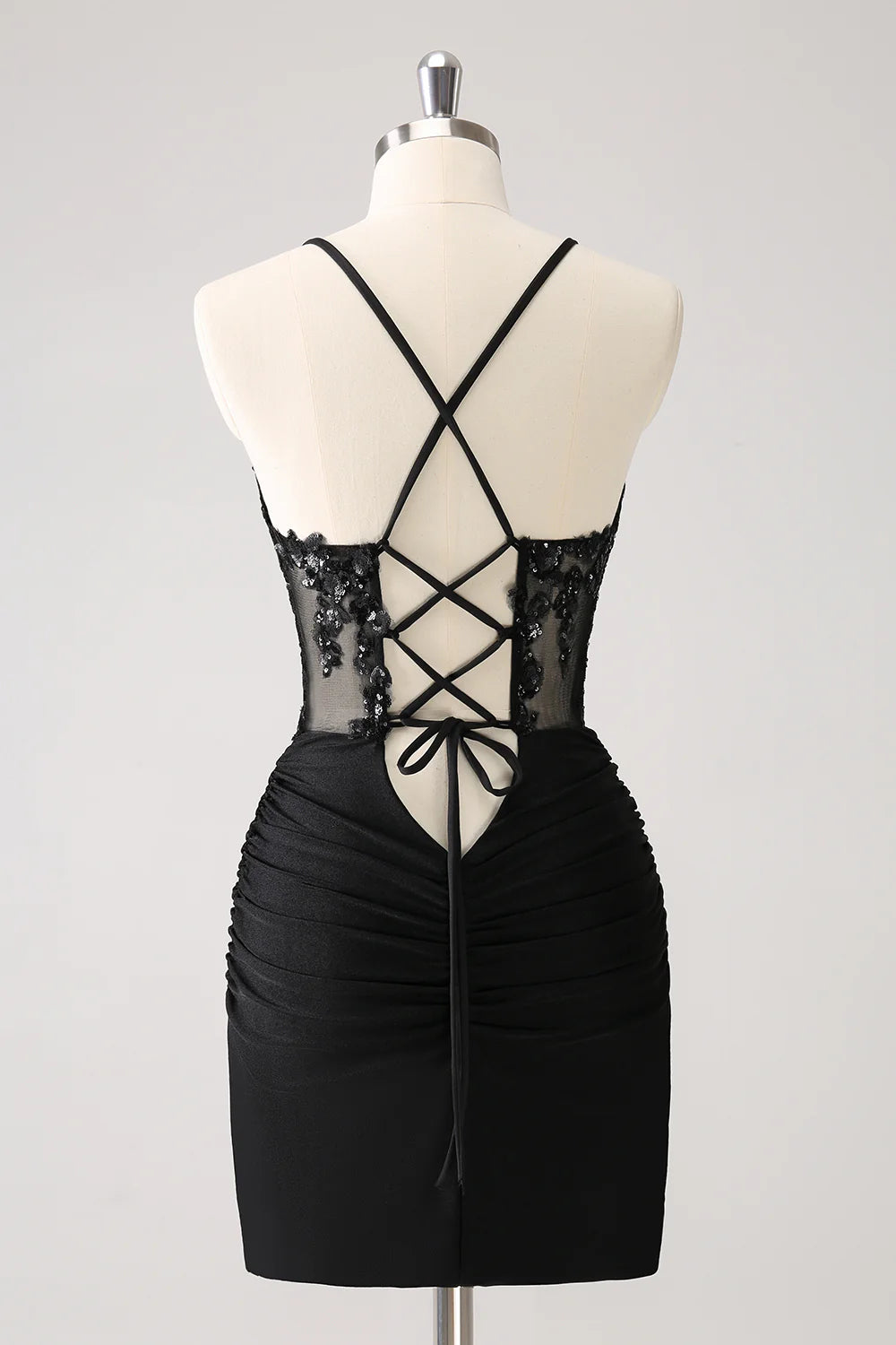 Close-up of the lace-up back detail on a black sequin homecoming dress.