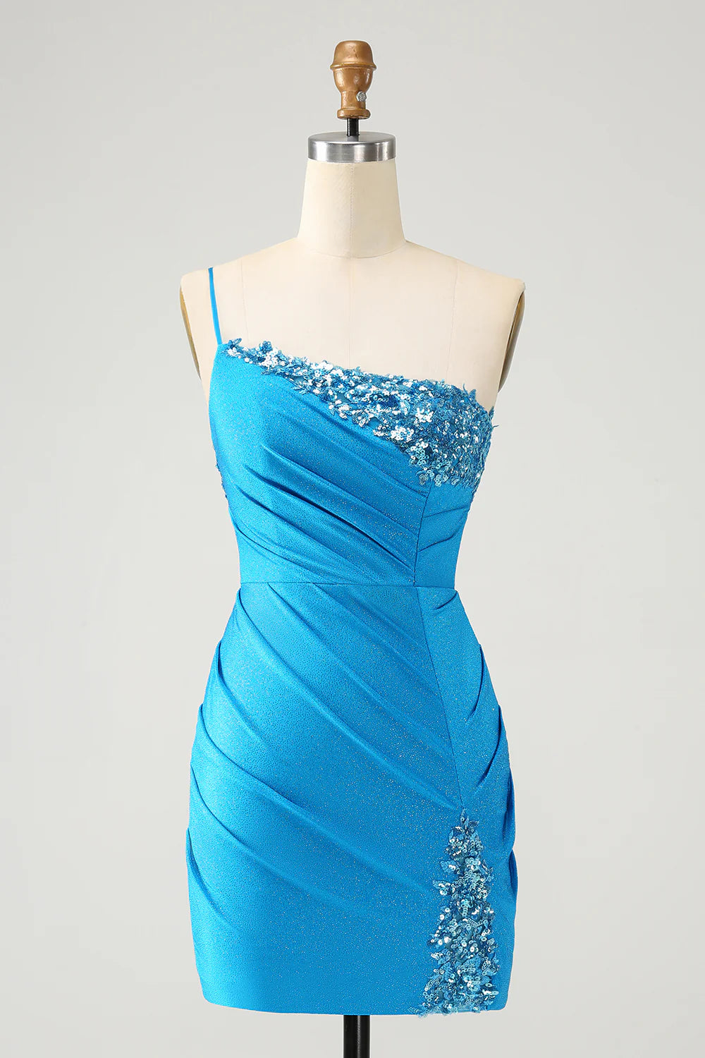 Model wearing a sparkly blue bodycon one-shoulder pleated short homecoming dress with sequins.