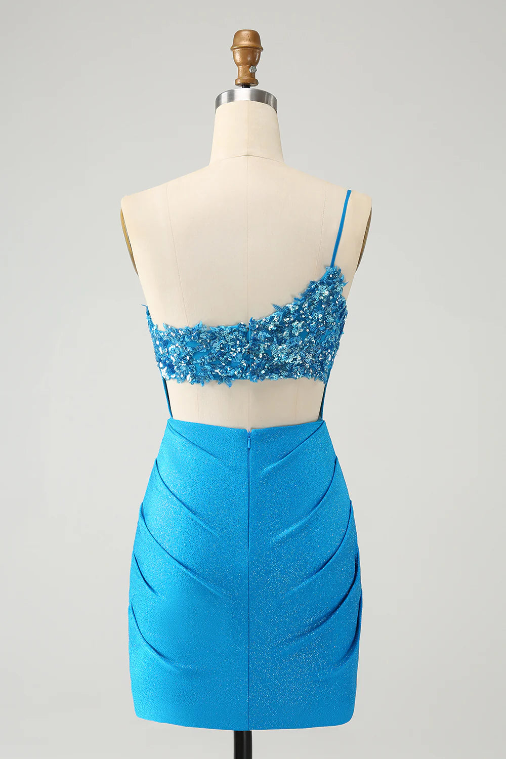 Back view of a model in a sparkly blue bodycon one-shoulder pleated short homecoming dress.