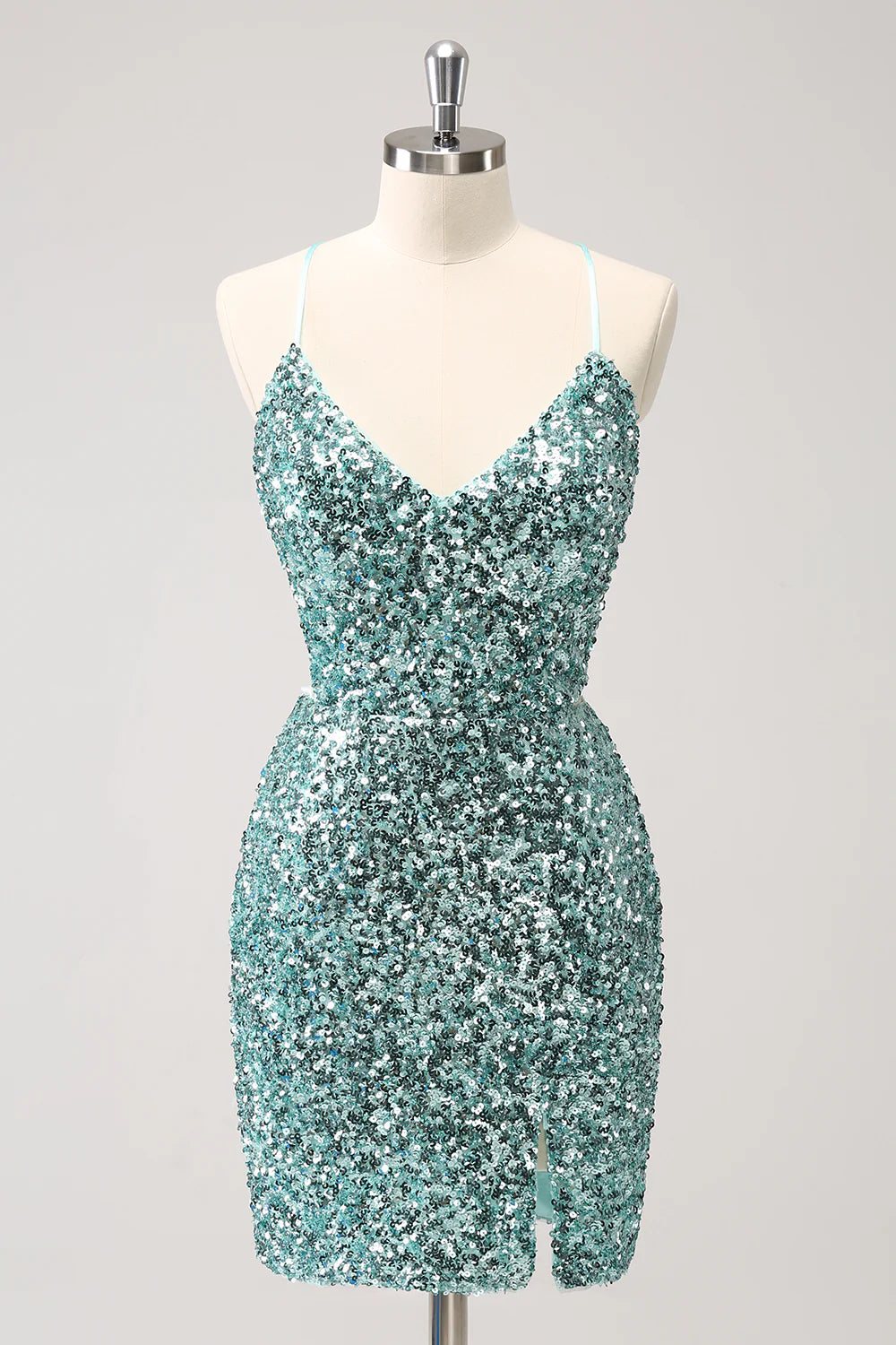 Woman wearing a sparkly blue sequin short homecoming dress with a front slit.