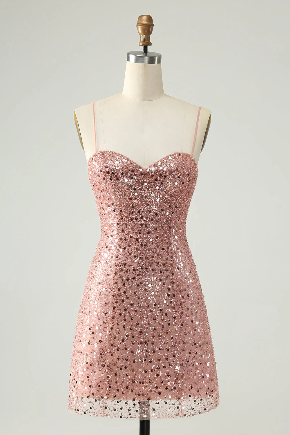 Blush A-line homecoming dress with spaghetti straps and all-over sequins.