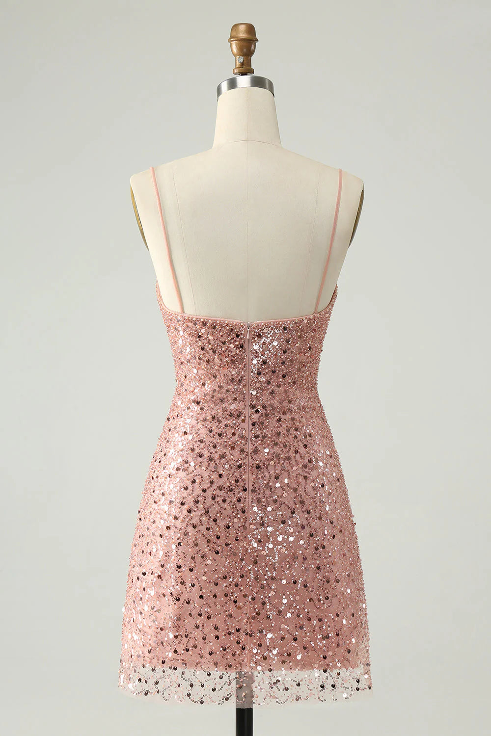 Back view of a sparkly blush short dress, featuring delicate spaghetti straps.