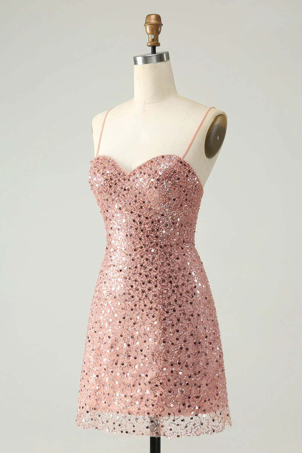 Side view of a sequined blush homecoming dress, showcasing its A-line silhouette.