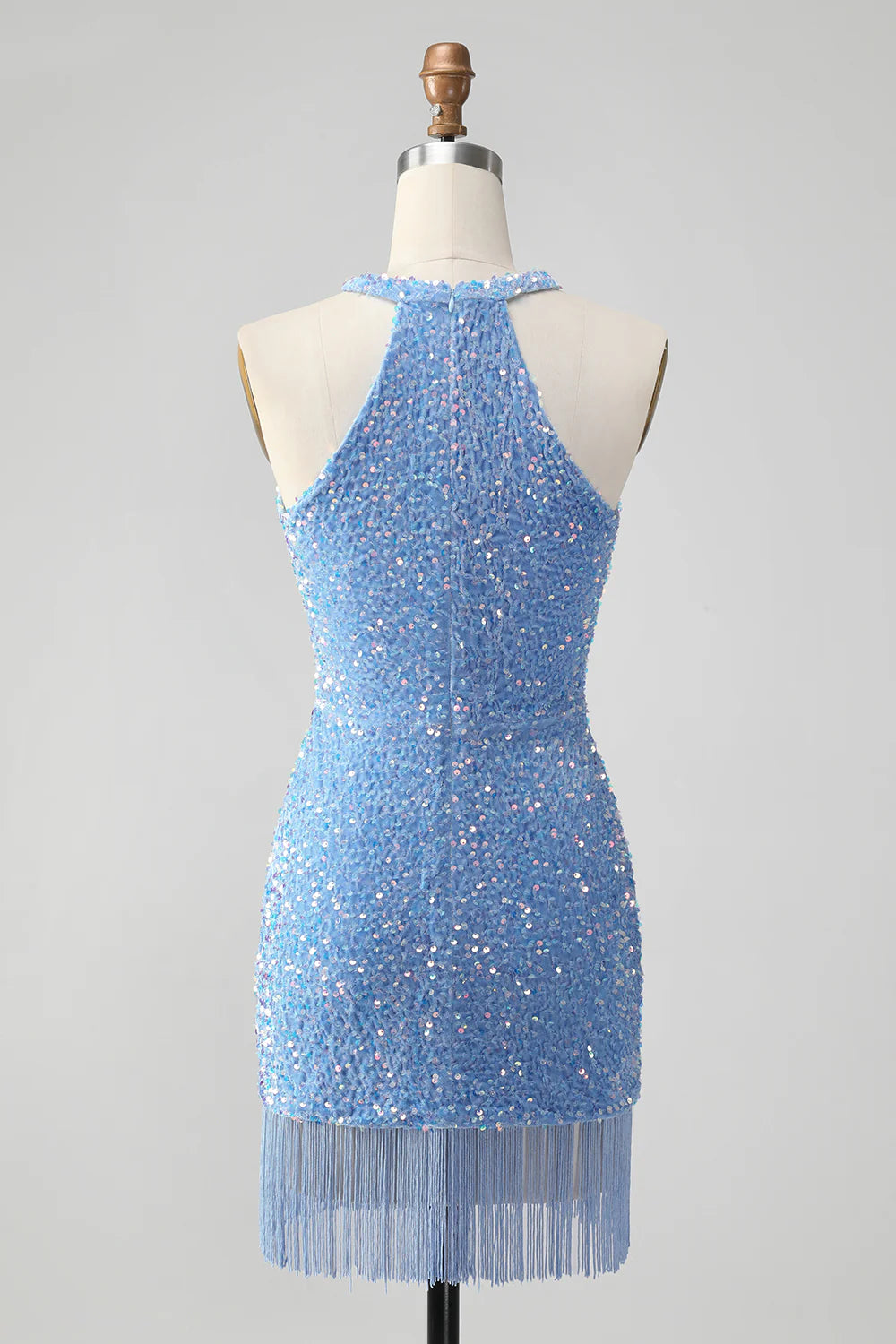 Model posing in a royal blue sequin short dress, showcasing the tassels.