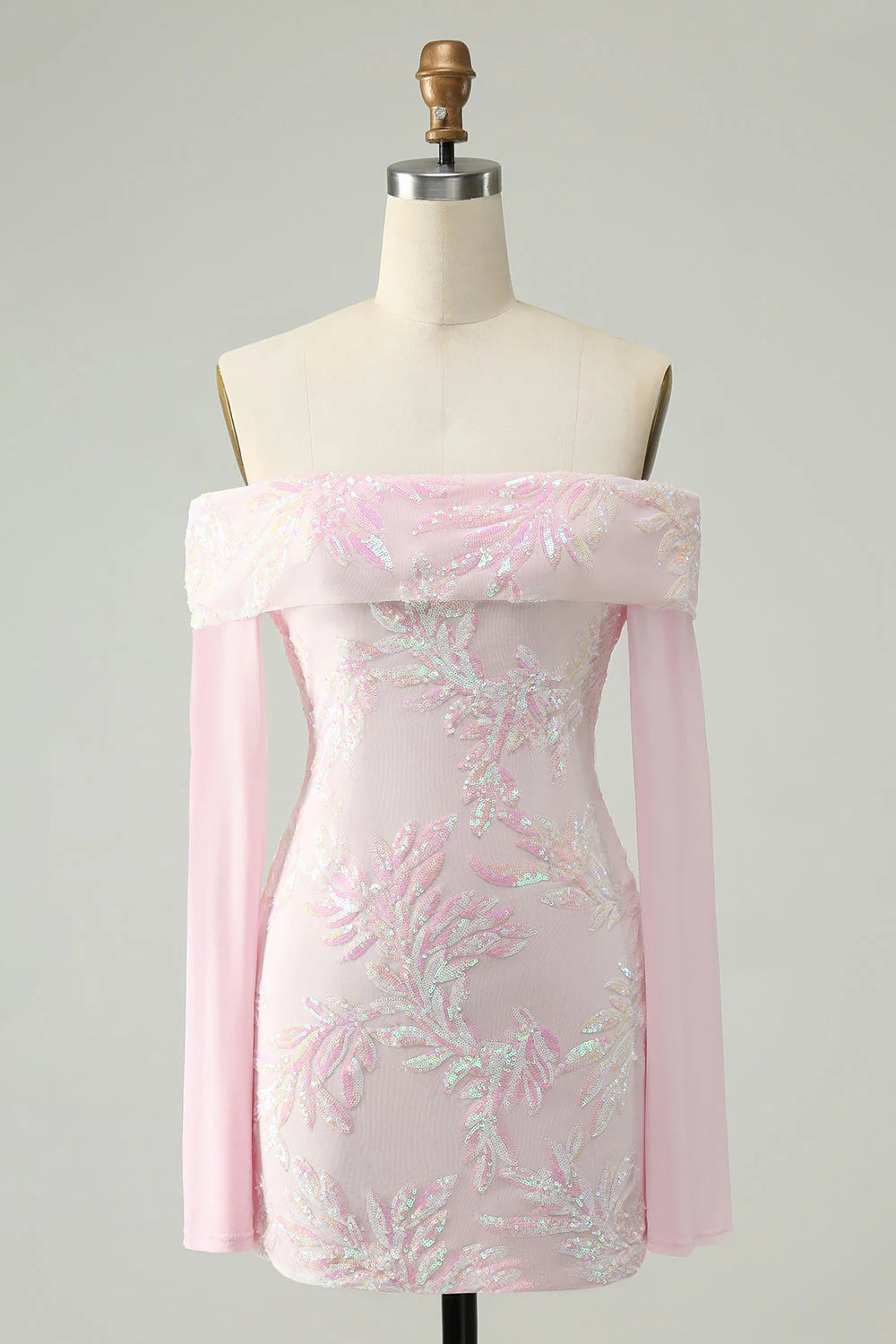 Model wearing a sparkly pink sequin bodycon off-the-shoulder homecoming dress with long sleeves.