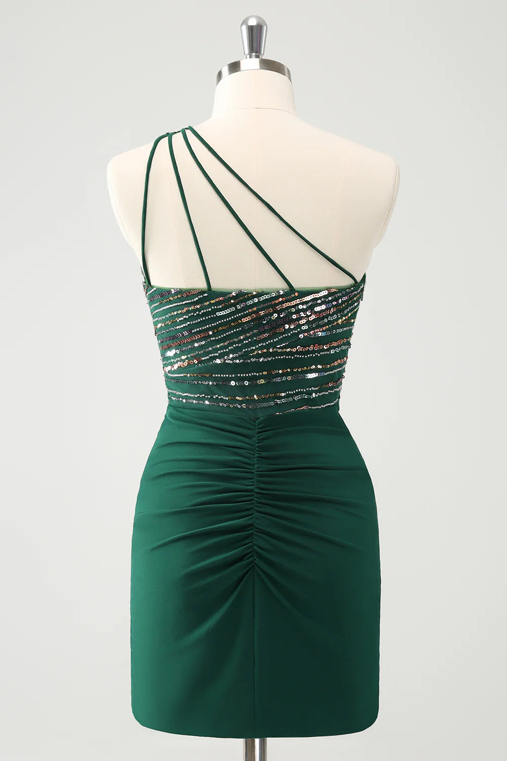Side view of dark green sequin bodycon dress with pleated detail.