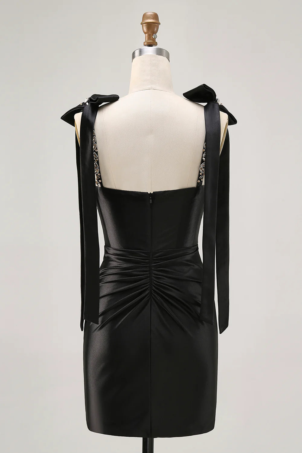 Sparkly black short homecoming dress with rhinestone details and spaghetti straps.