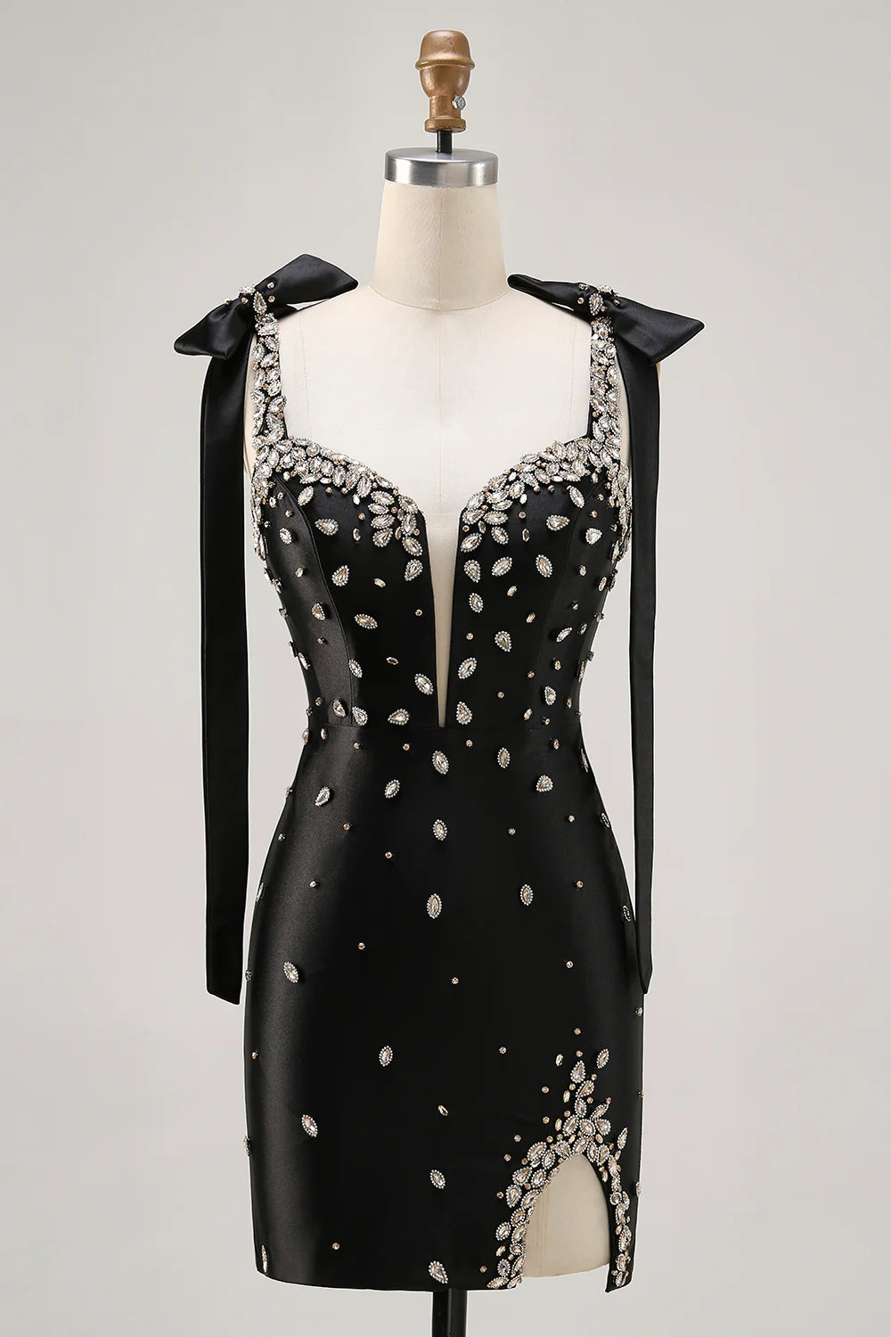 Back view of a sparkly black bodycon dress featuring spaghetti straps.